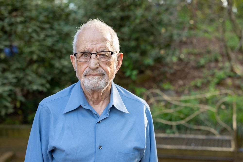 Bubjan with book and speaking to camera