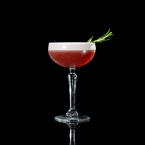 A closeup of a Pomegranate Cape Cod drink against a dark background.