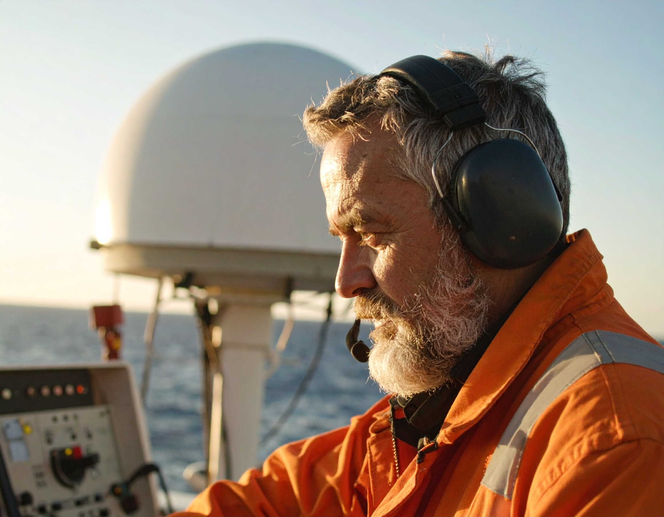 naval operator with satellite dome in background
