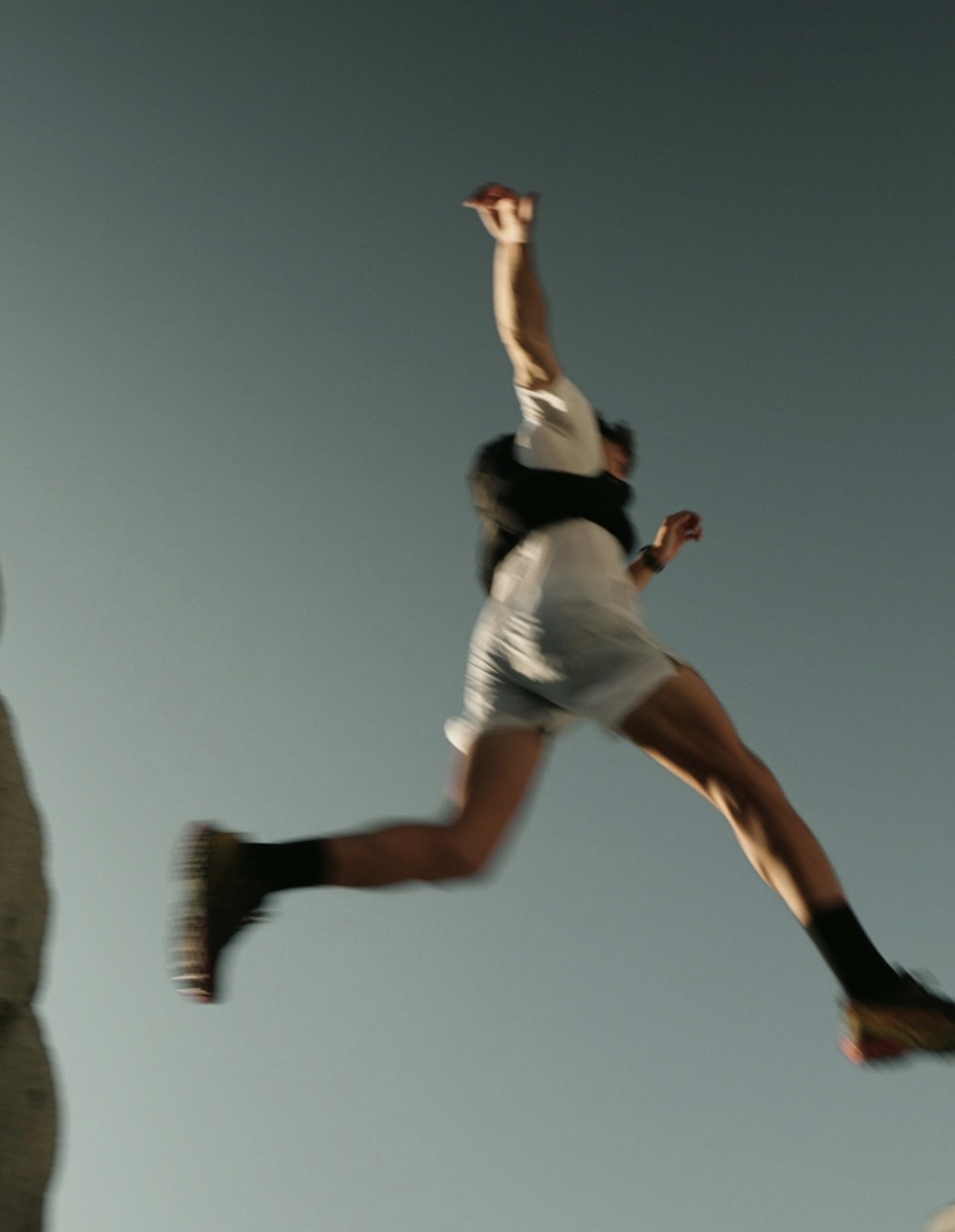 Trail runner jumping during a descent