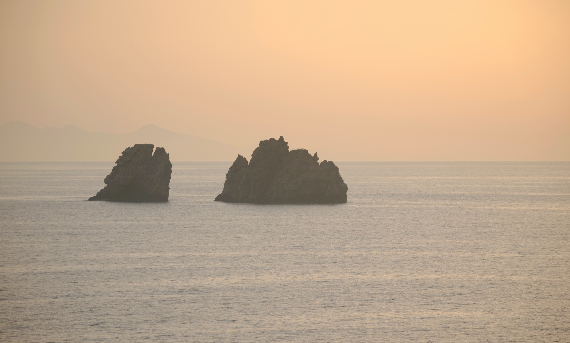 Sunset photo of "Portes", the stones that mark the beginning of Paros