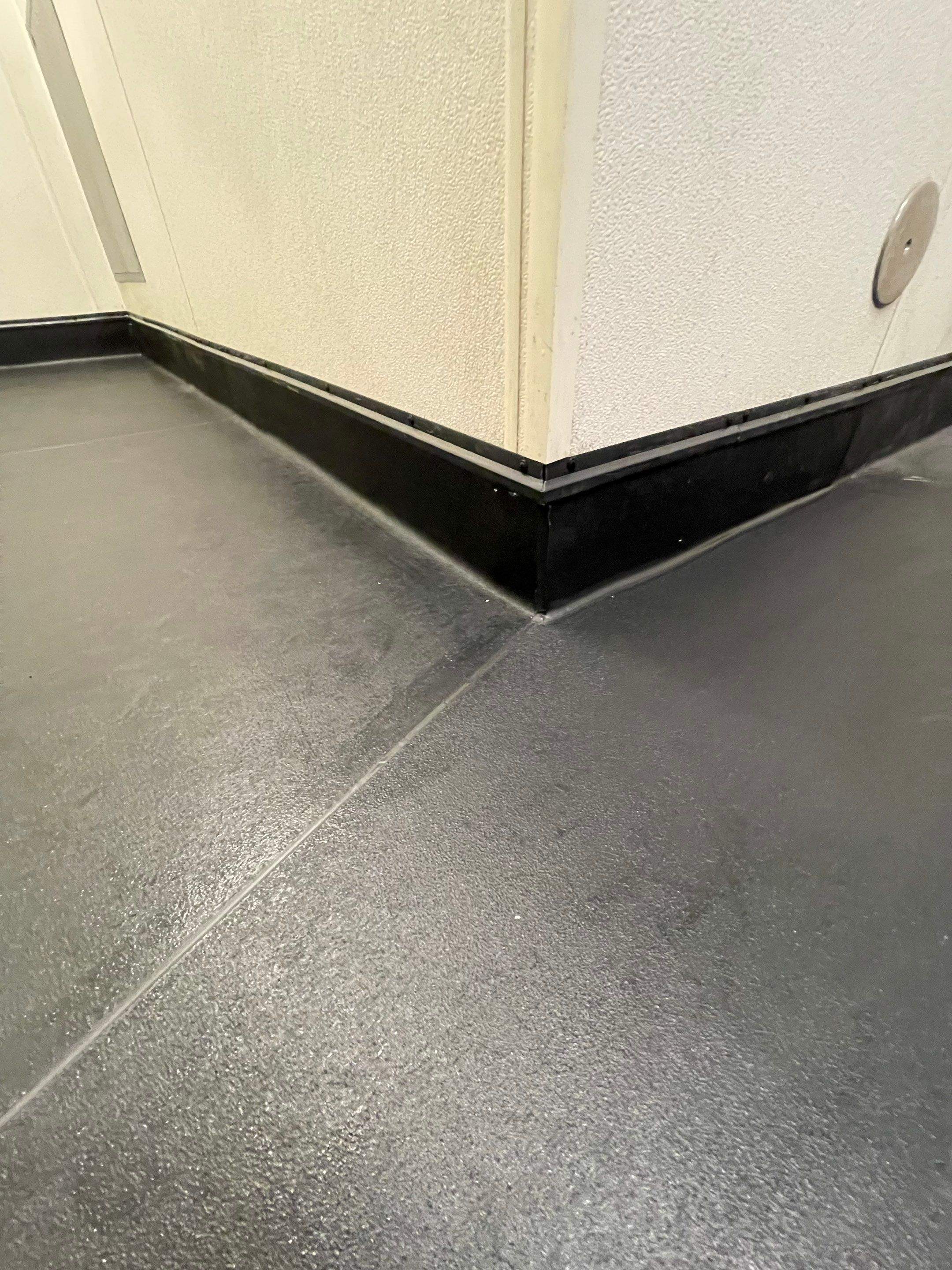 Seamless Eco-Grip installation around drains and corners, emphasizing precision and clean workmanship.