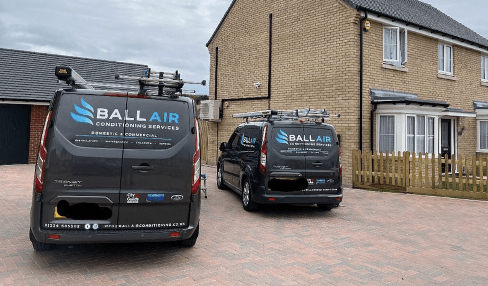 Modern bathroom featuring a walk-in shower, wooden vanity, round mirror, and elegant marble tiles.