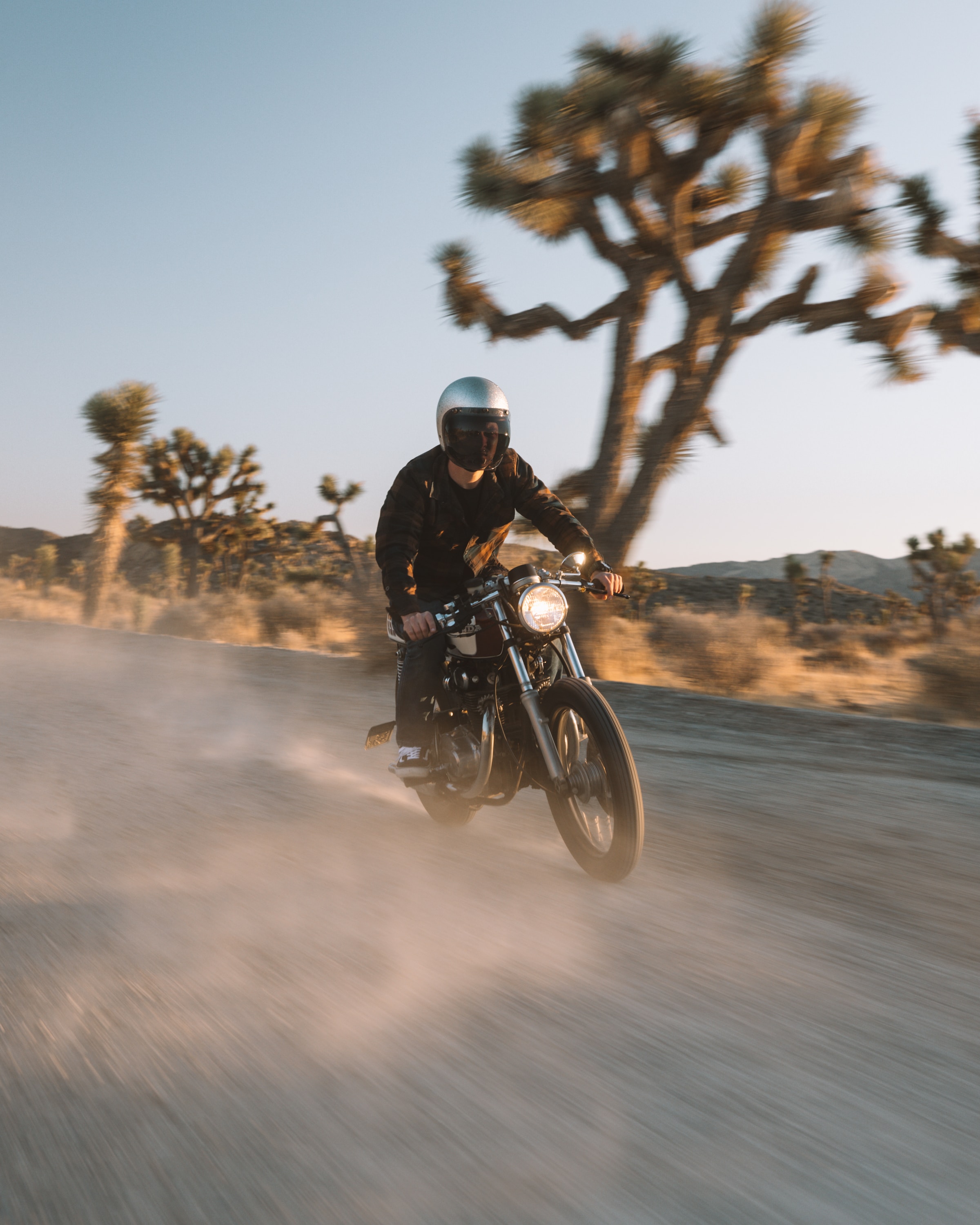 A motorcycle driving on a sandy road