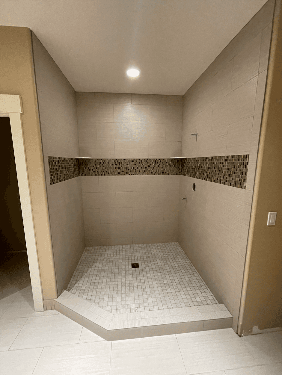 Mosaic tile walk-in shower with accent band by Dream Tiles LLC