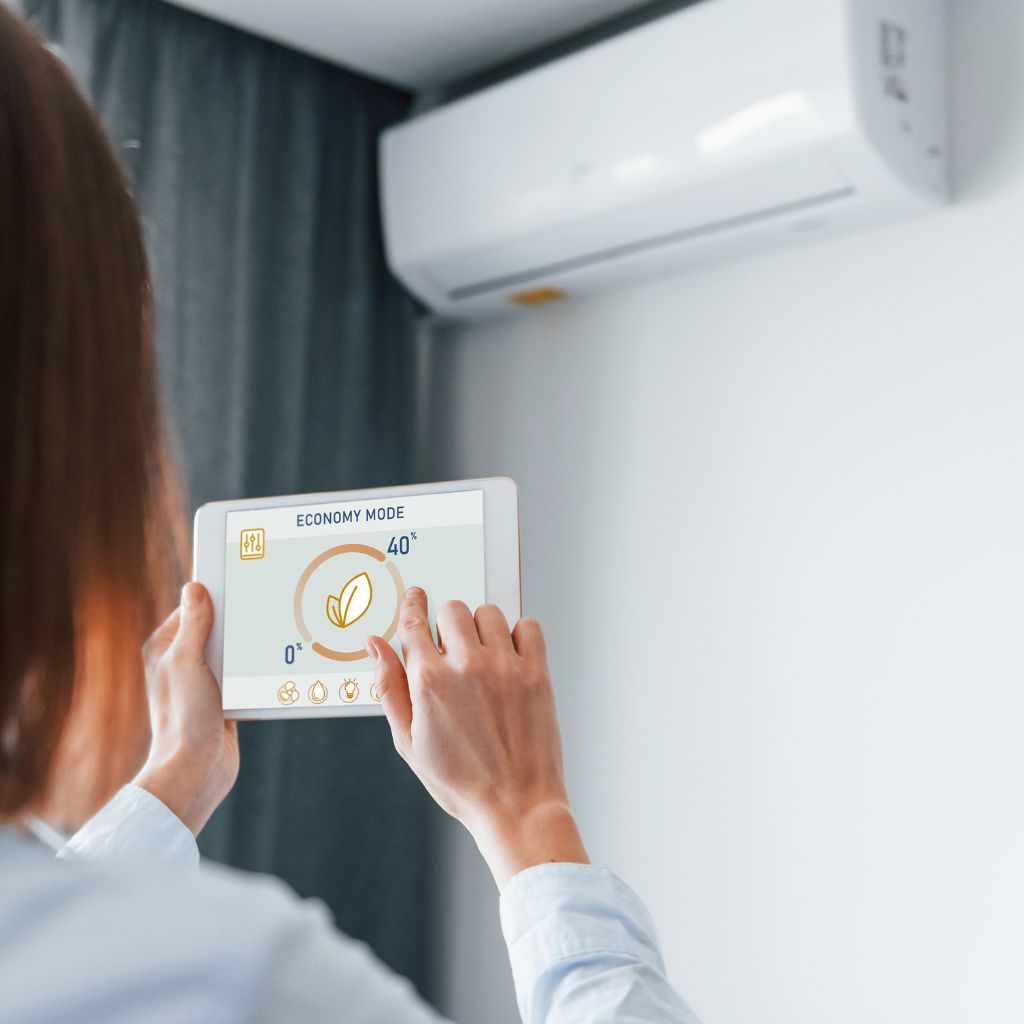 a woman controlling an air conditioner