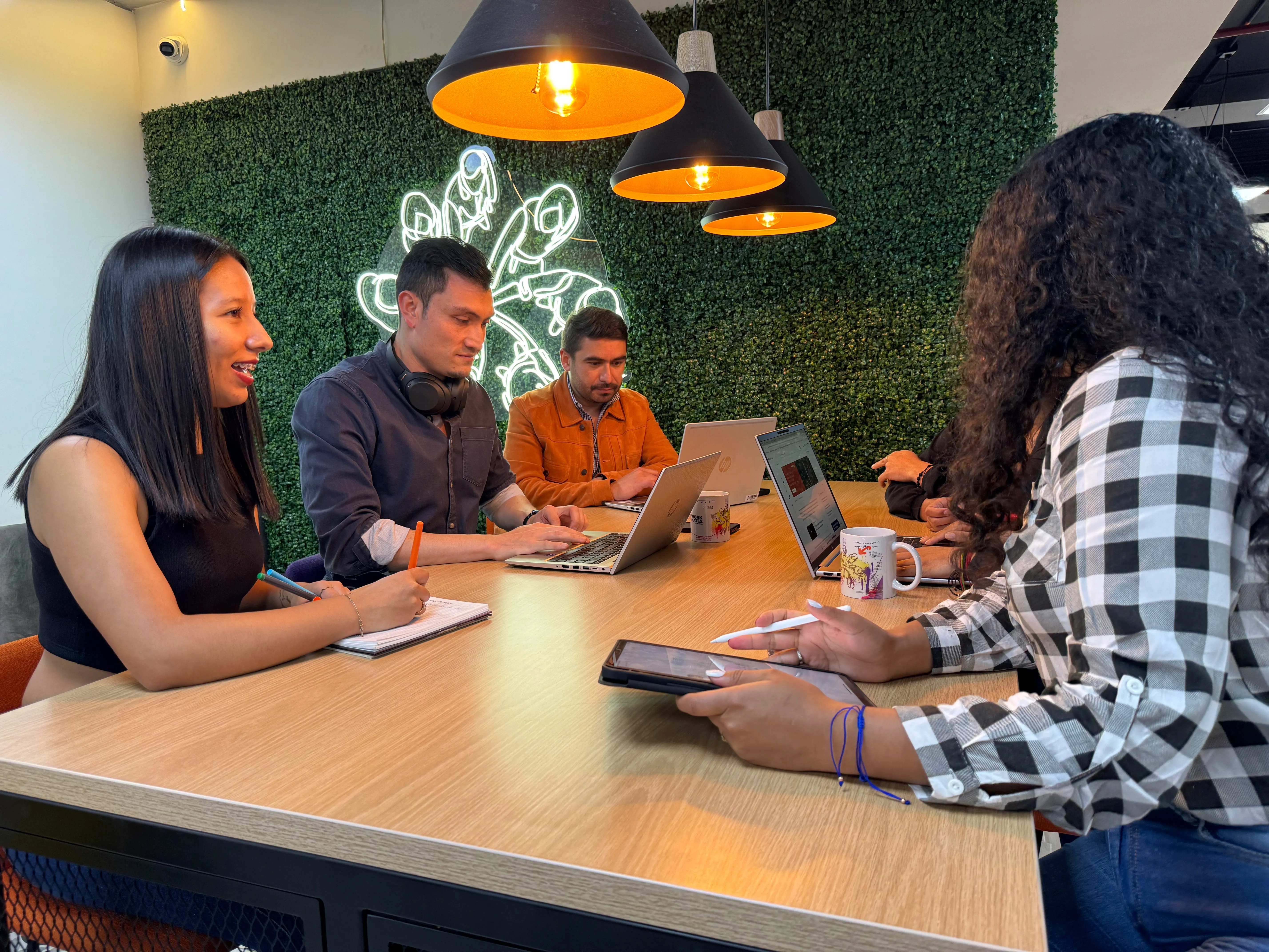 Personas sentadas en una mesa trabajando juntas