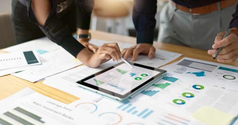 person analyzing business charts on laptop