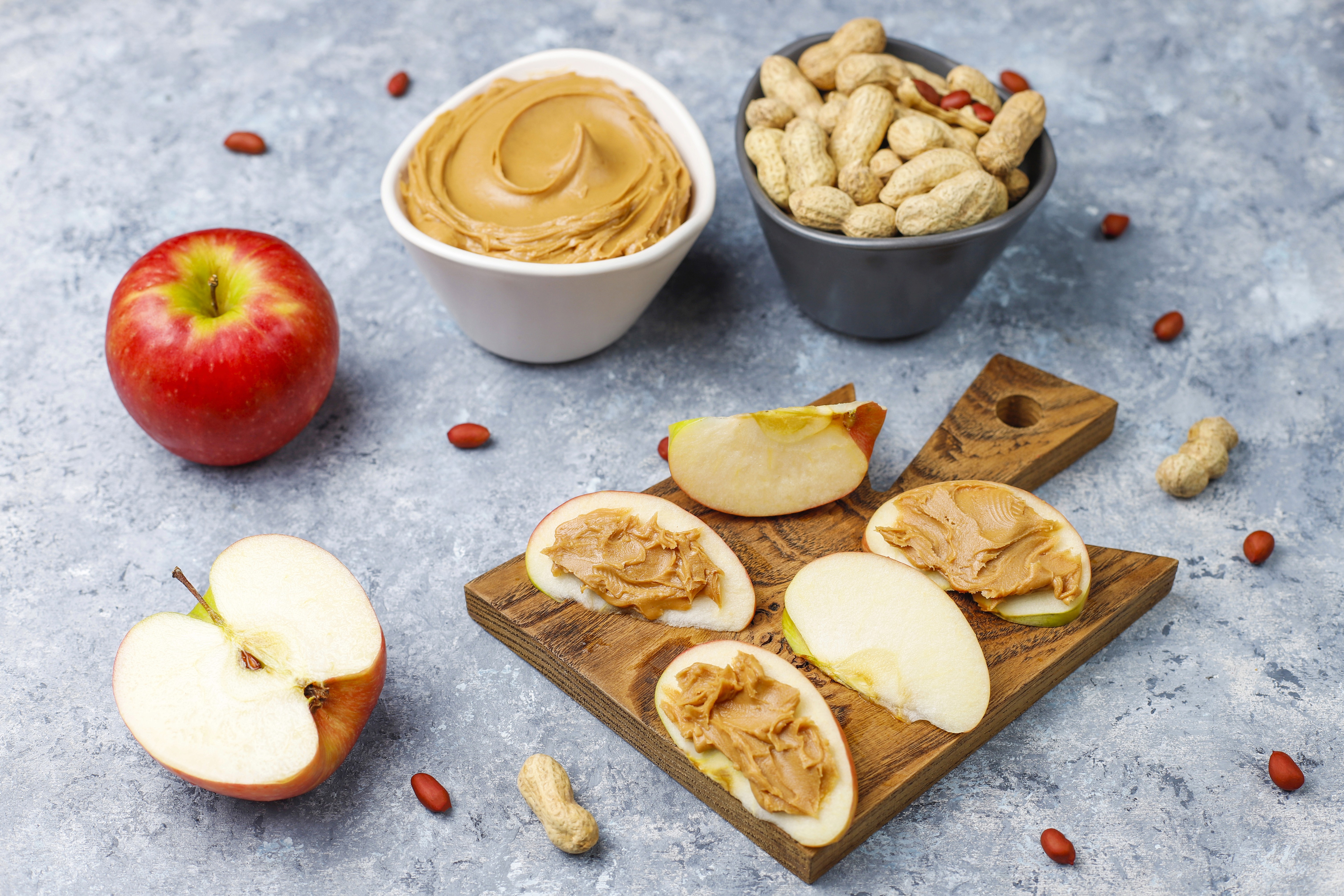 Fresh apple slices spread with creamy peanut butter
