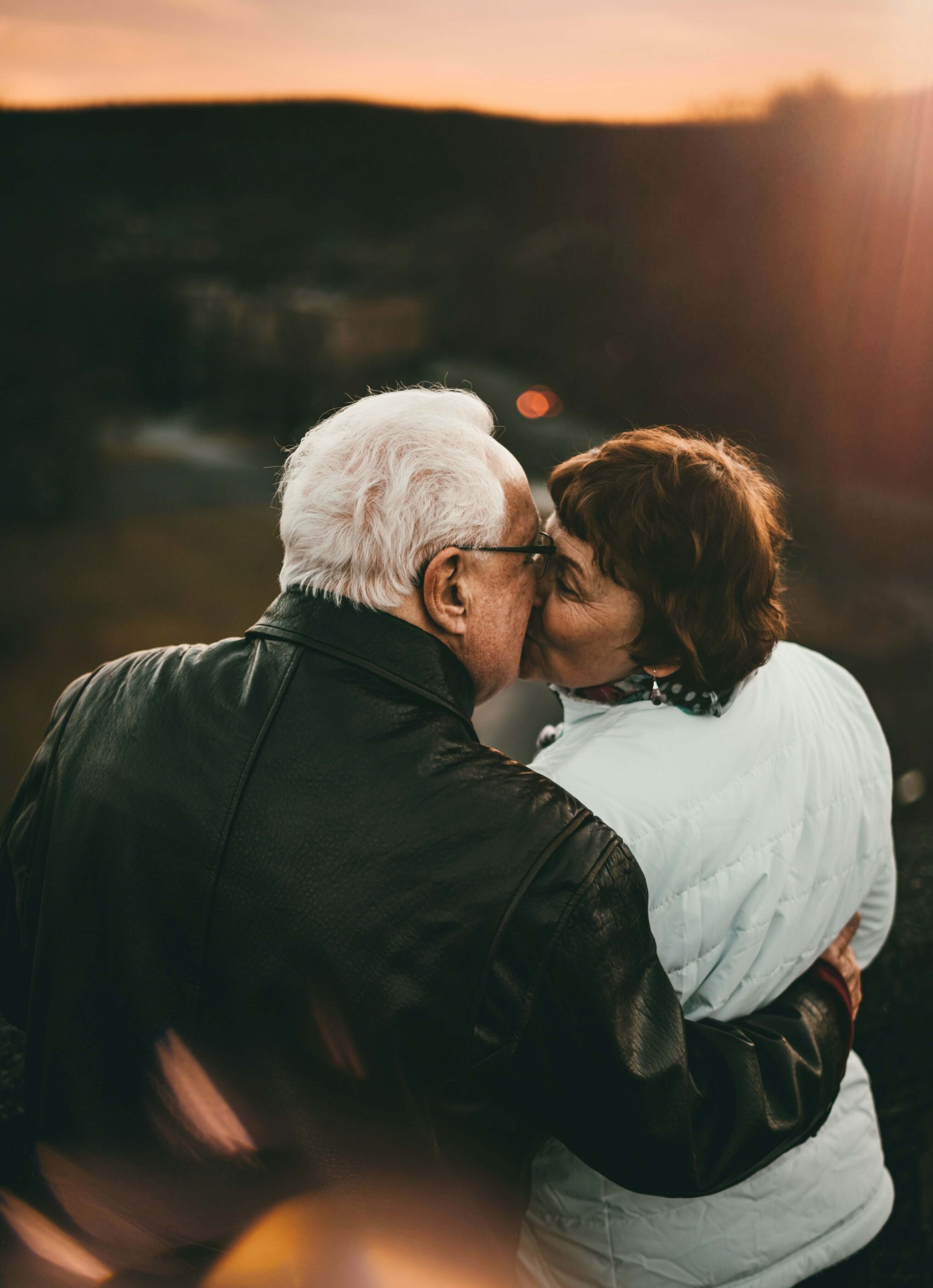 Image of an older couple kissing.