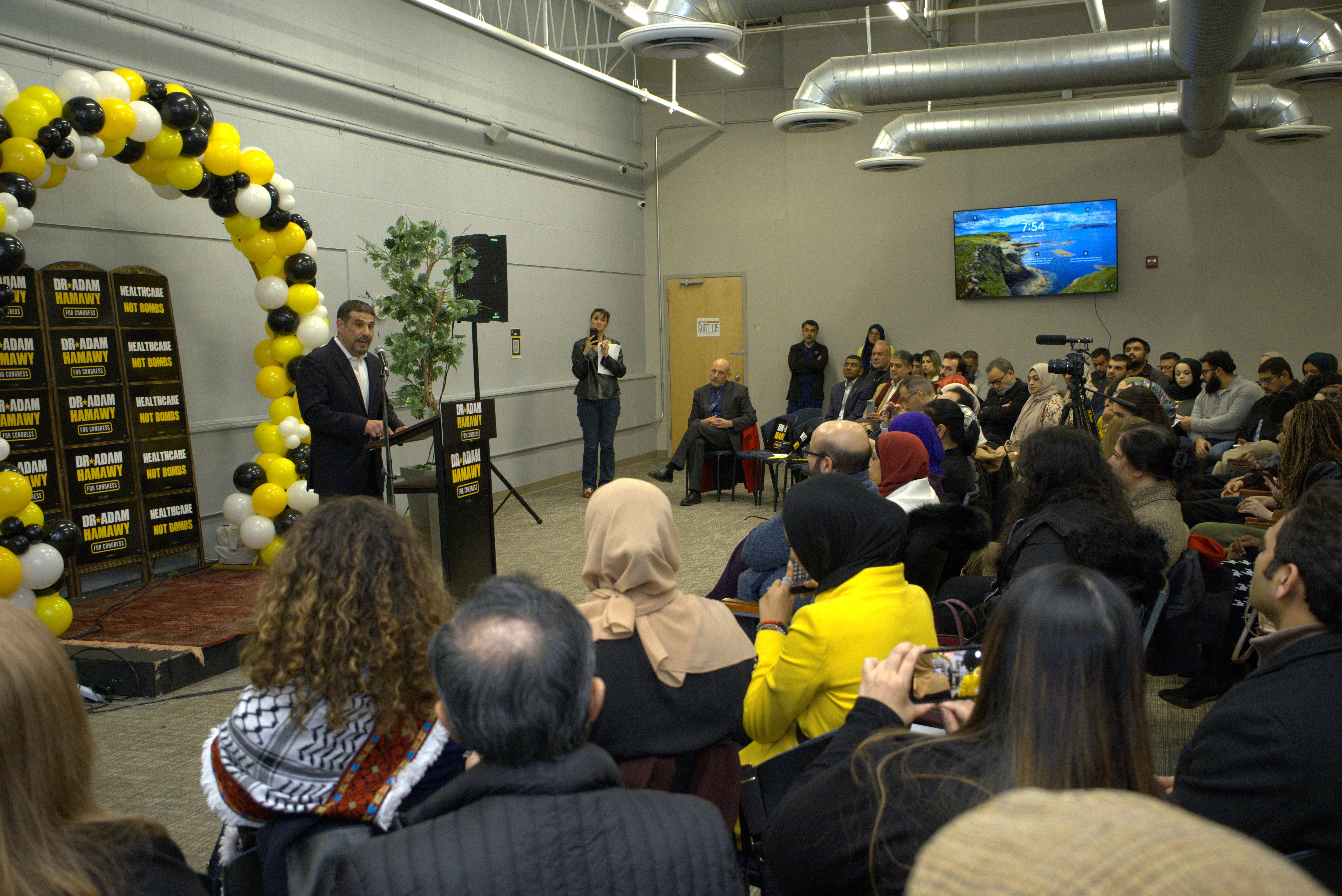 Dr. Adam Hamawy speaking to a crowd at a community campaign event in New Jersey District 12