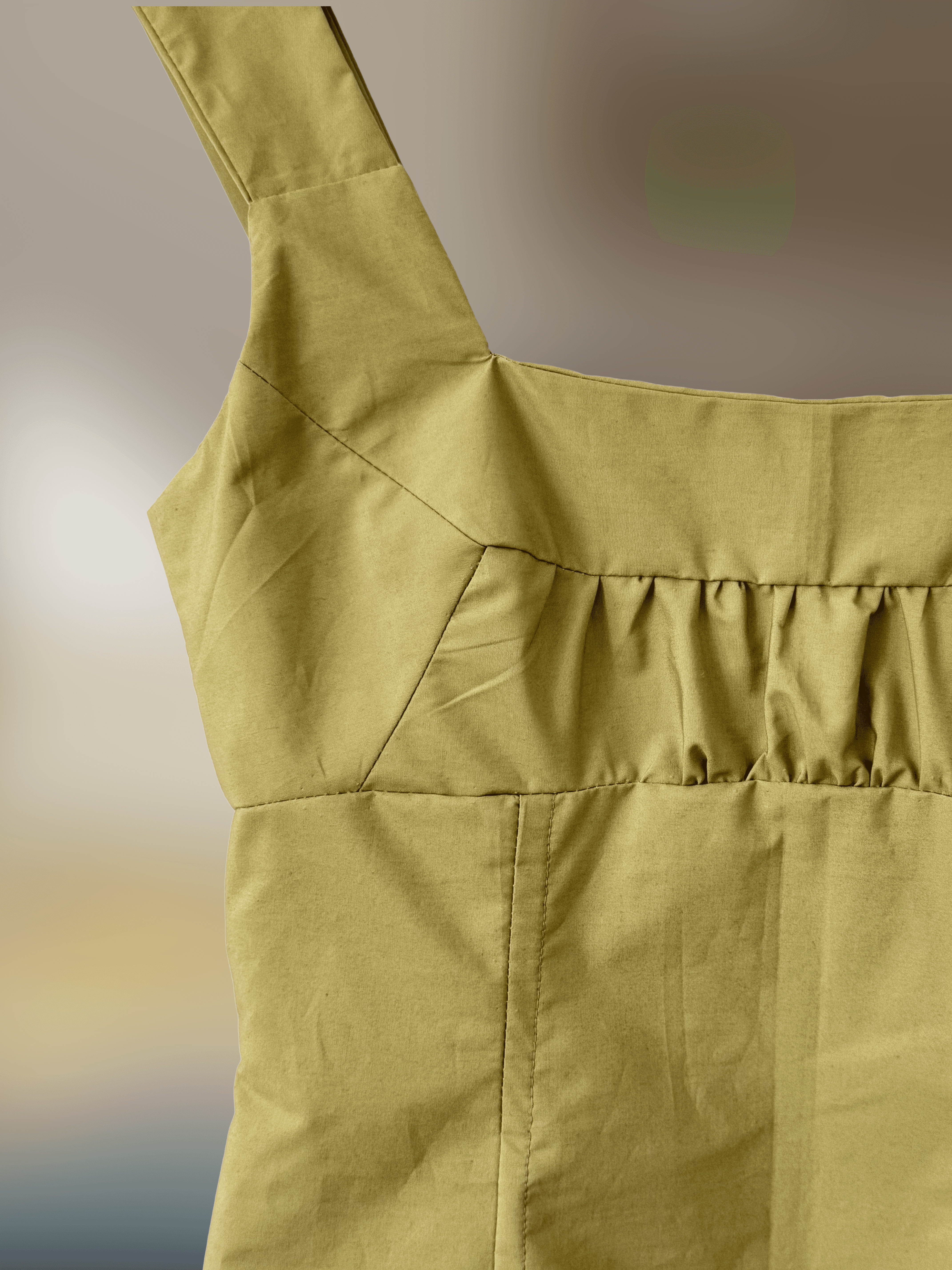 close up of the intricate top section of a green dress