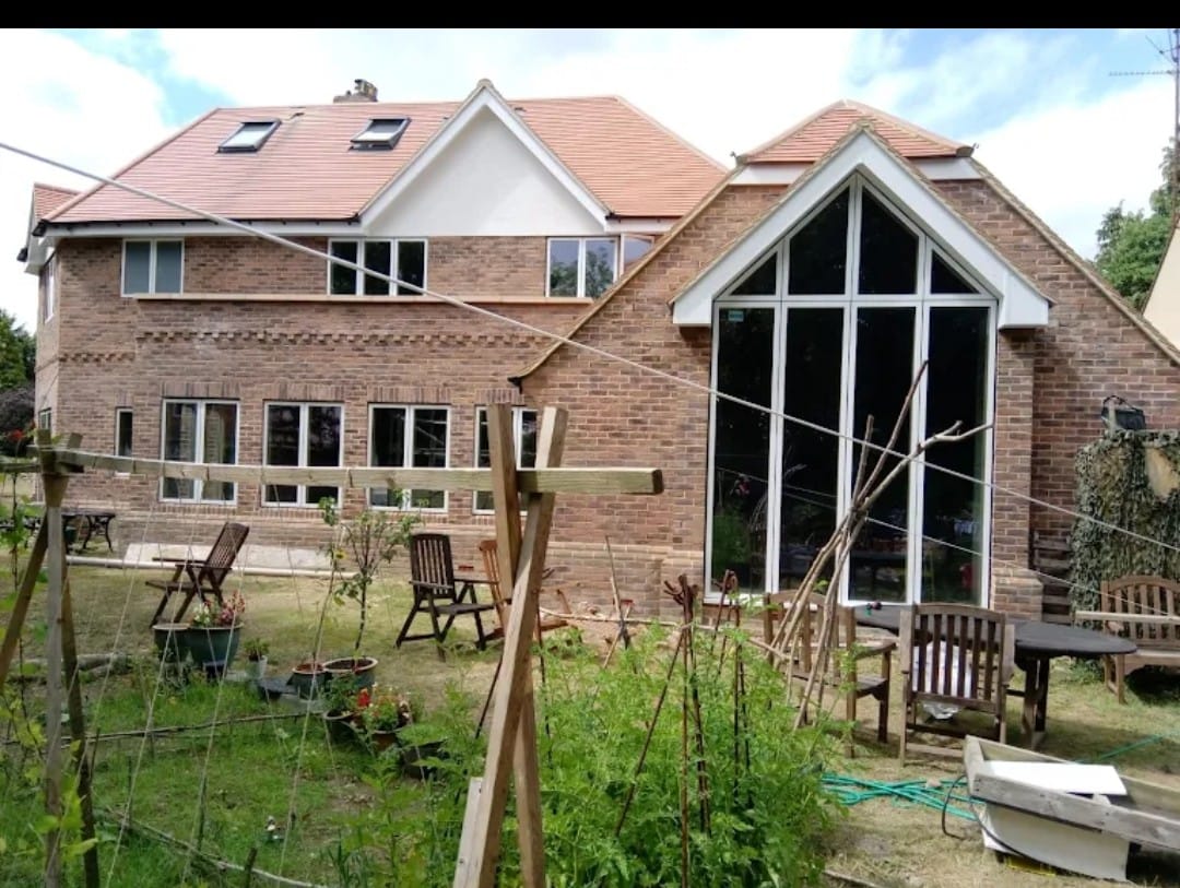 a row of red brick houses next to a road