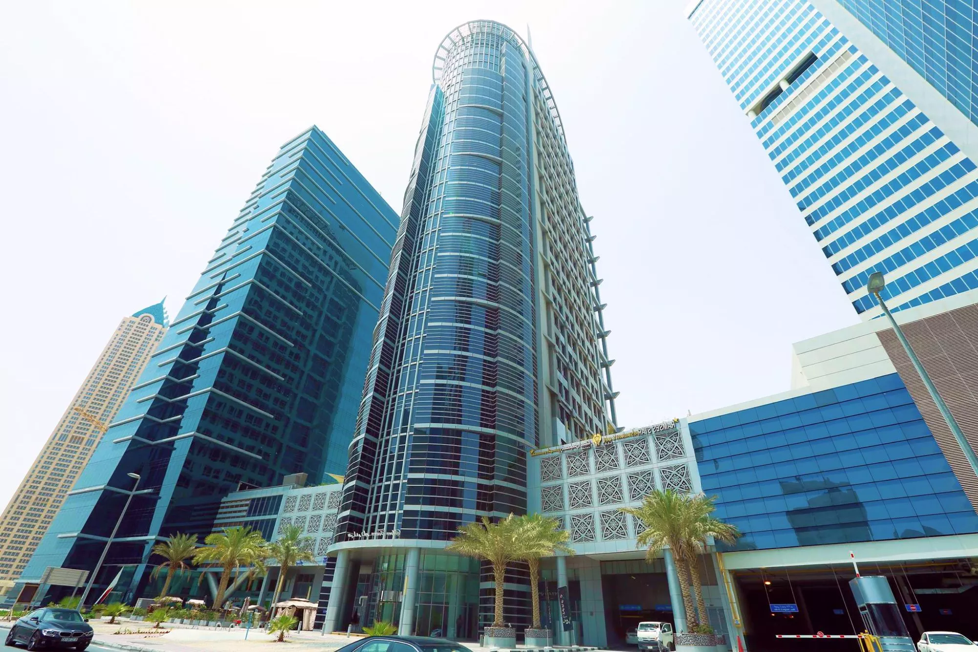 Wide-angle view of Silver Tower surrounded by modern glass infrastructure in the business district.