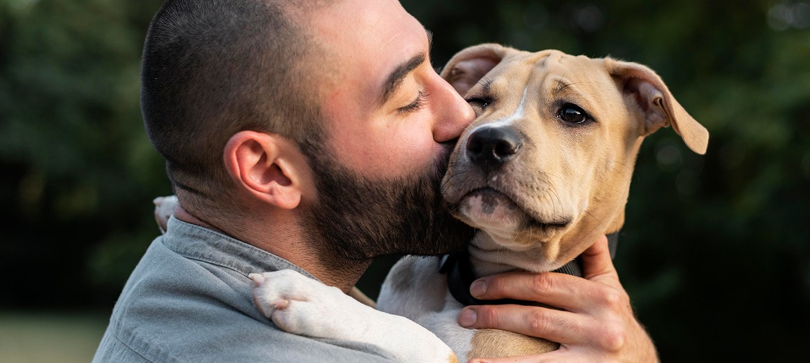 A person stands in a sandstone cave.