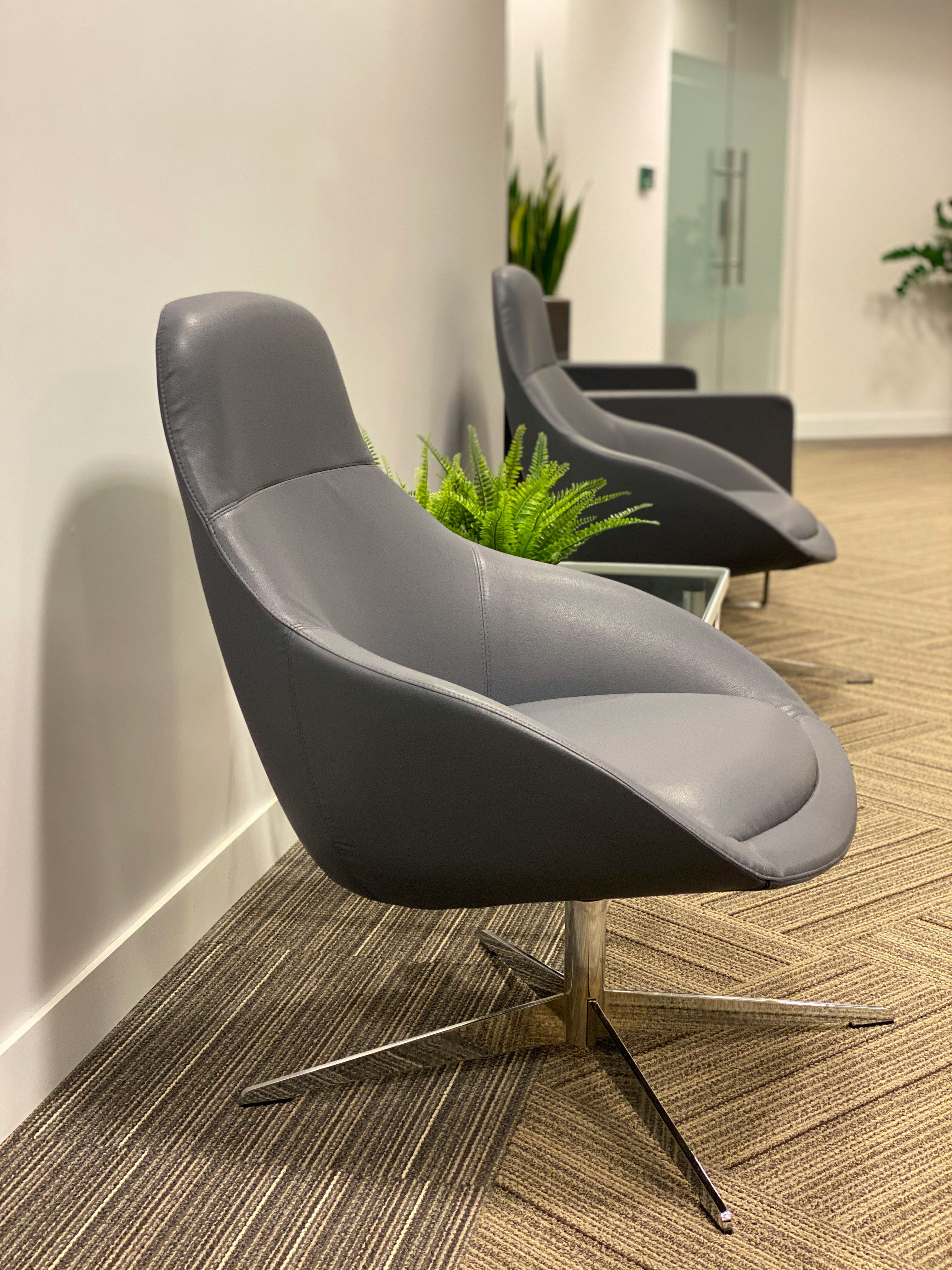 black leather padded chair on brown and gray carpet