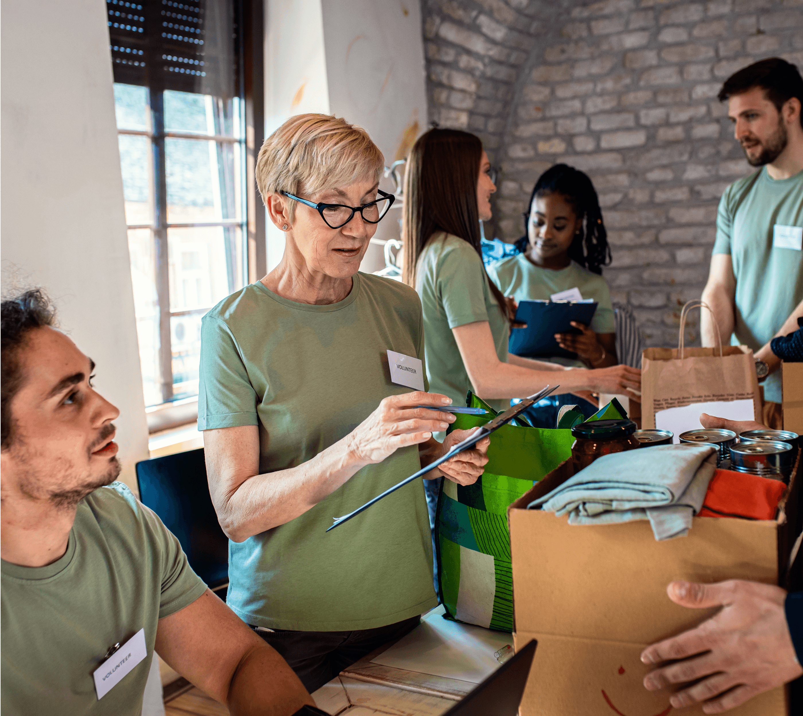 A group of people in green shirts engaging in coordinating activities at a community event or workspace.