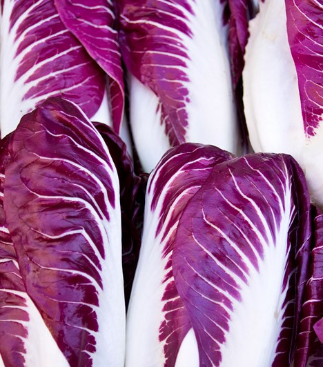 two people looking at a tablet and smiling