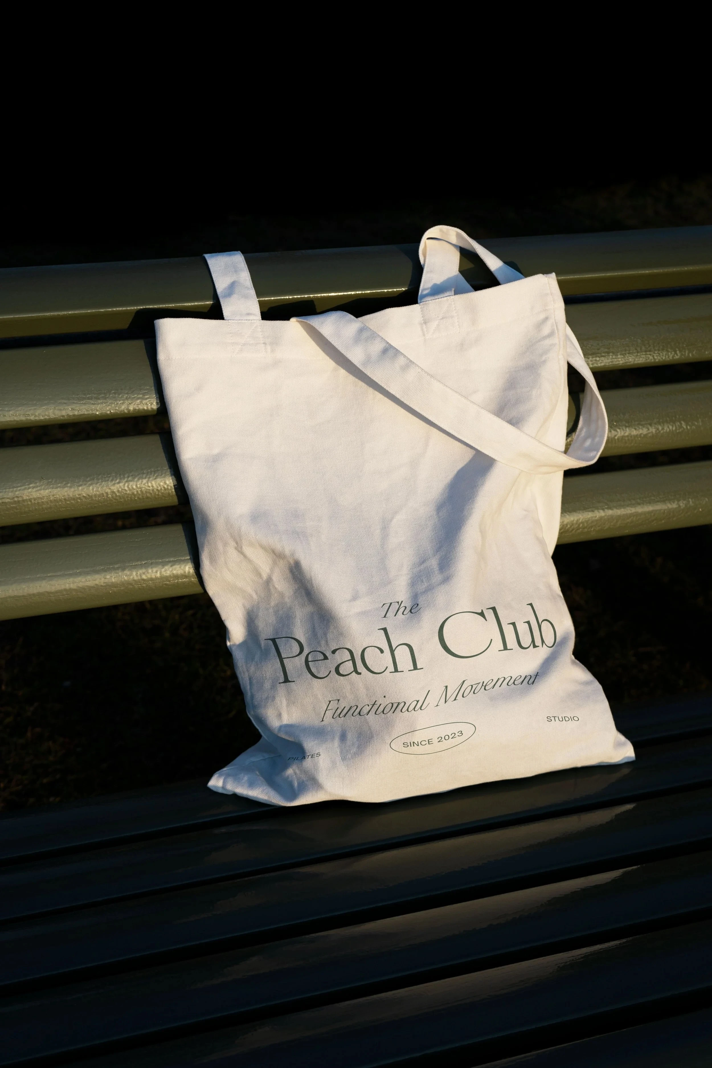 The Peach Club wordmark printed on a canvas tote bag.
