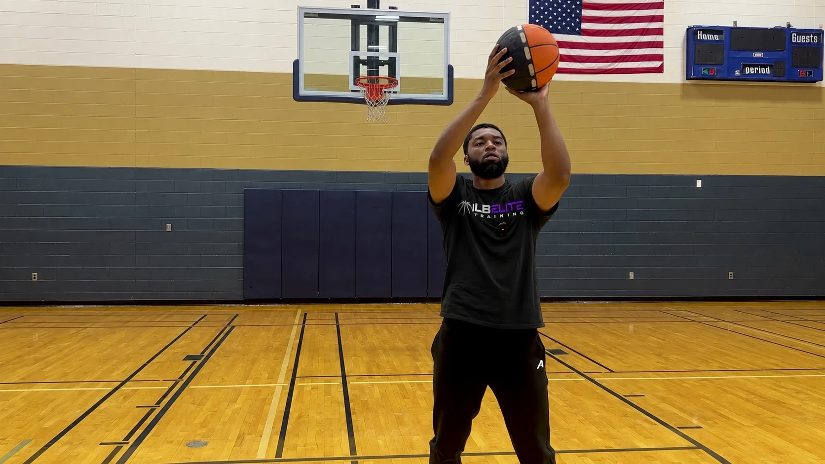 Coach Meech in an ILB Elite shirt practicing his shot with the Rotation Basketball