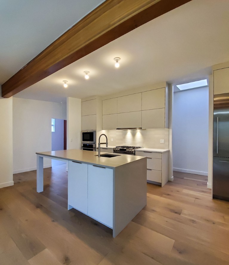 Image of Modern kitchen design with island, stainless steel appliances, and white cabinetry by KHD Homes.
