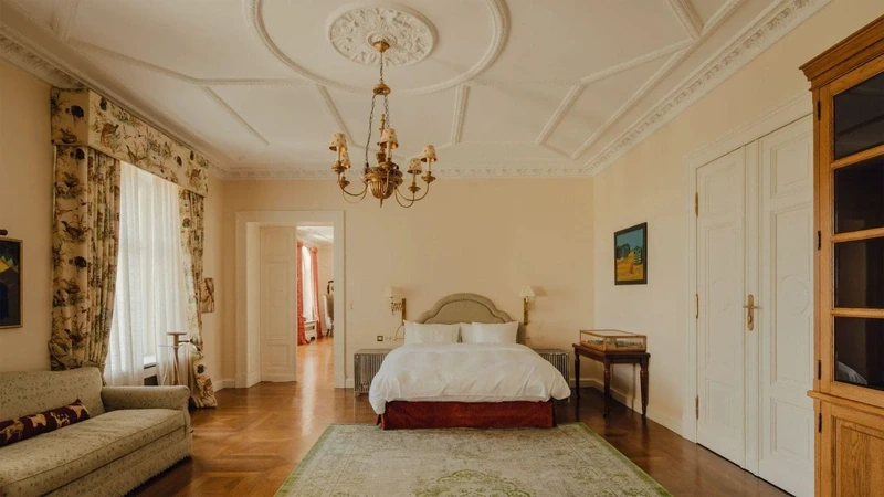 a palace bedroom with a large continental bed