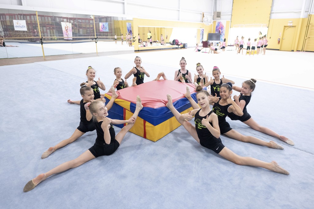 A group of gymnasts stretching their oversplits 