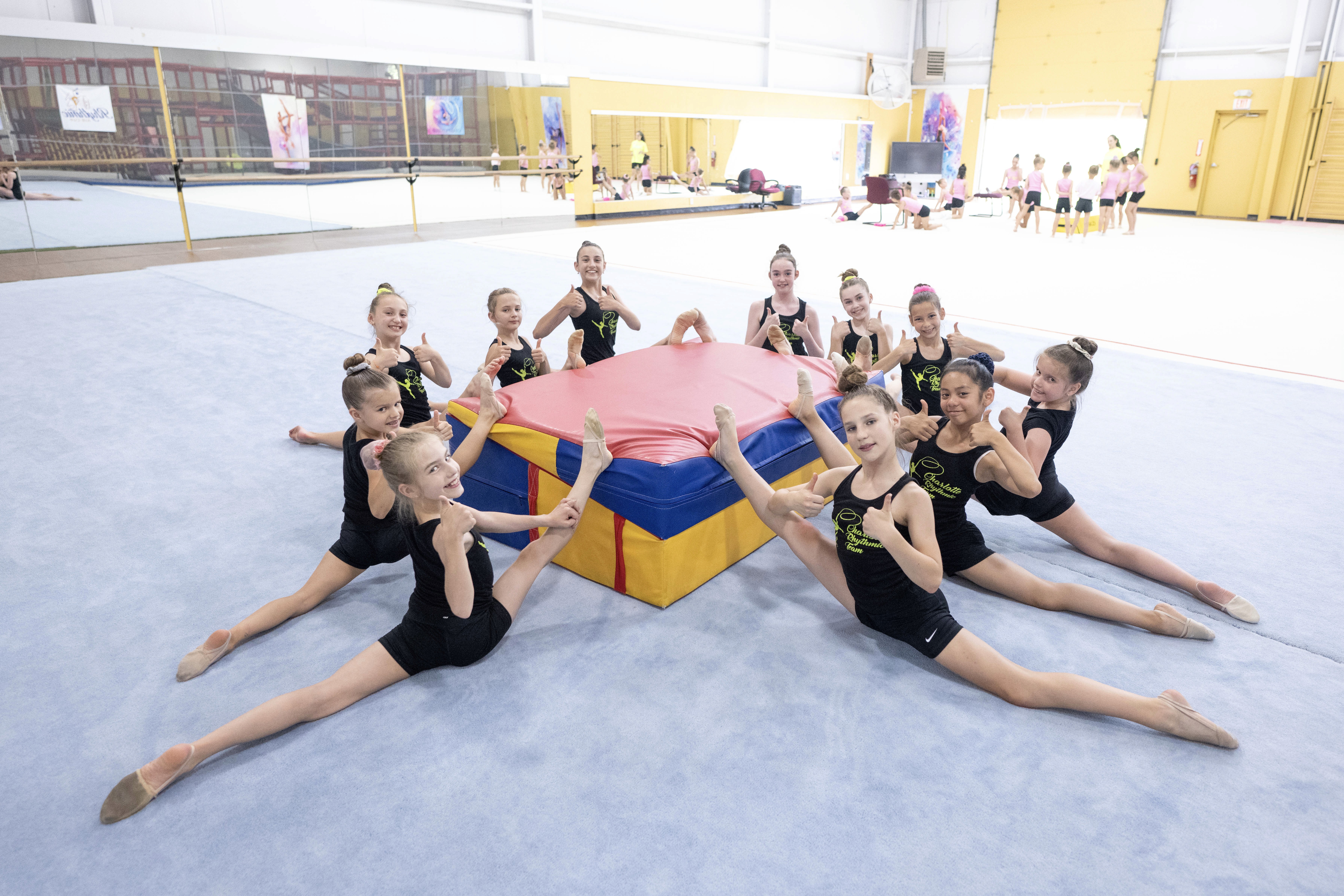 A group of gymnasts stretching their oversplits
