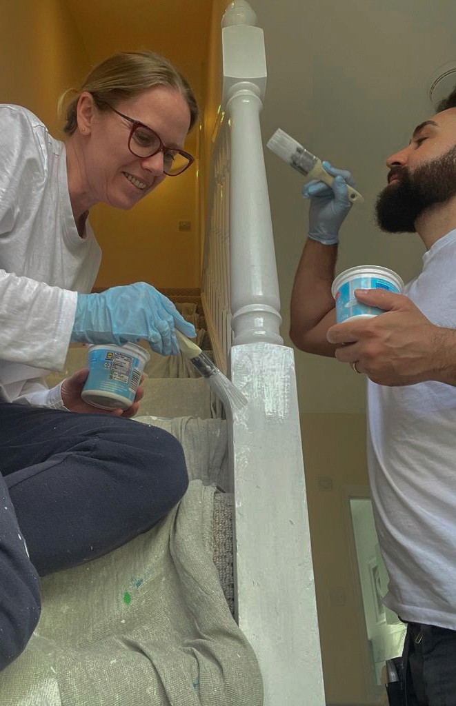 CEOs Alex and Patricia paintgin a stairwell together