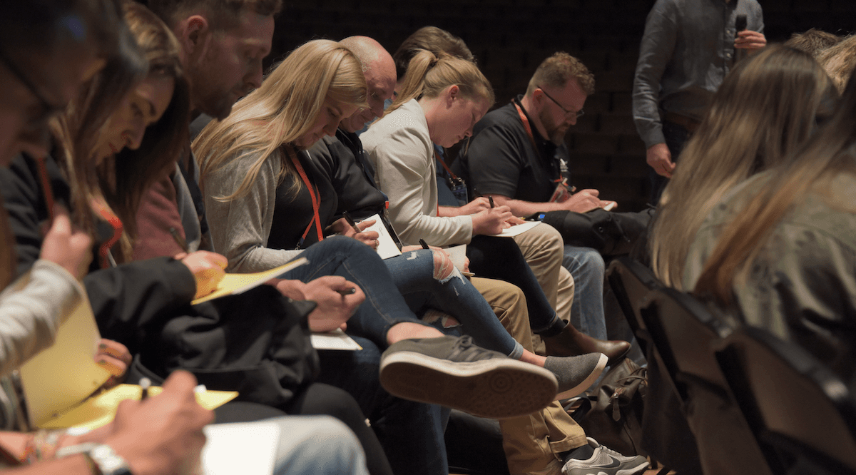 A designer at a well-lit desk, settled in deep focus, embodying native AI-fluent practice.