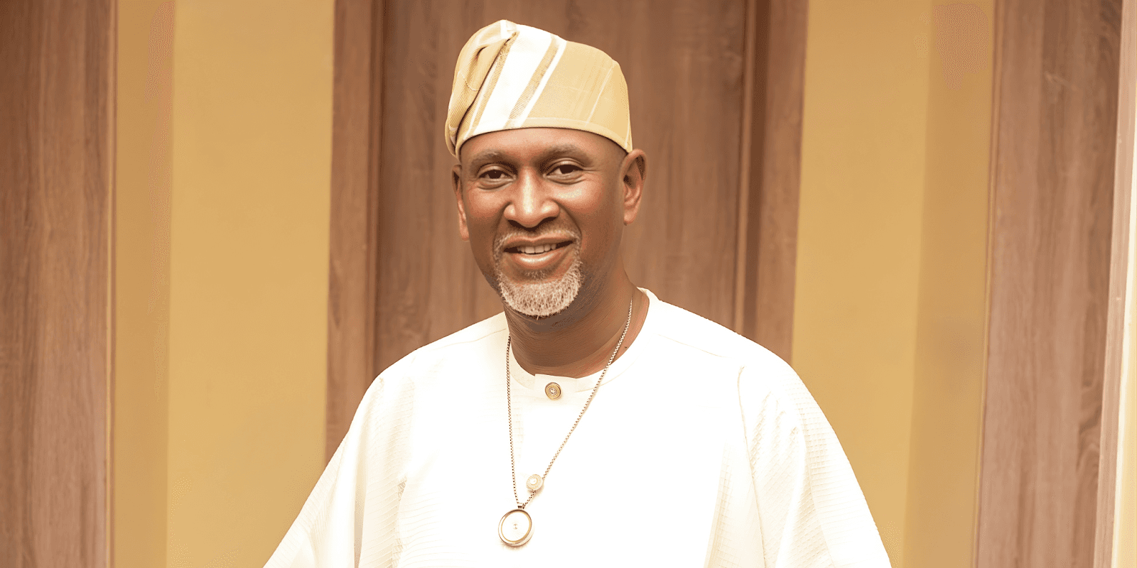 Dr. Akintoye Akindele, wearing a white shirt and gold hat, joins ISAMEA Global as an ambassador for peace and innovation.