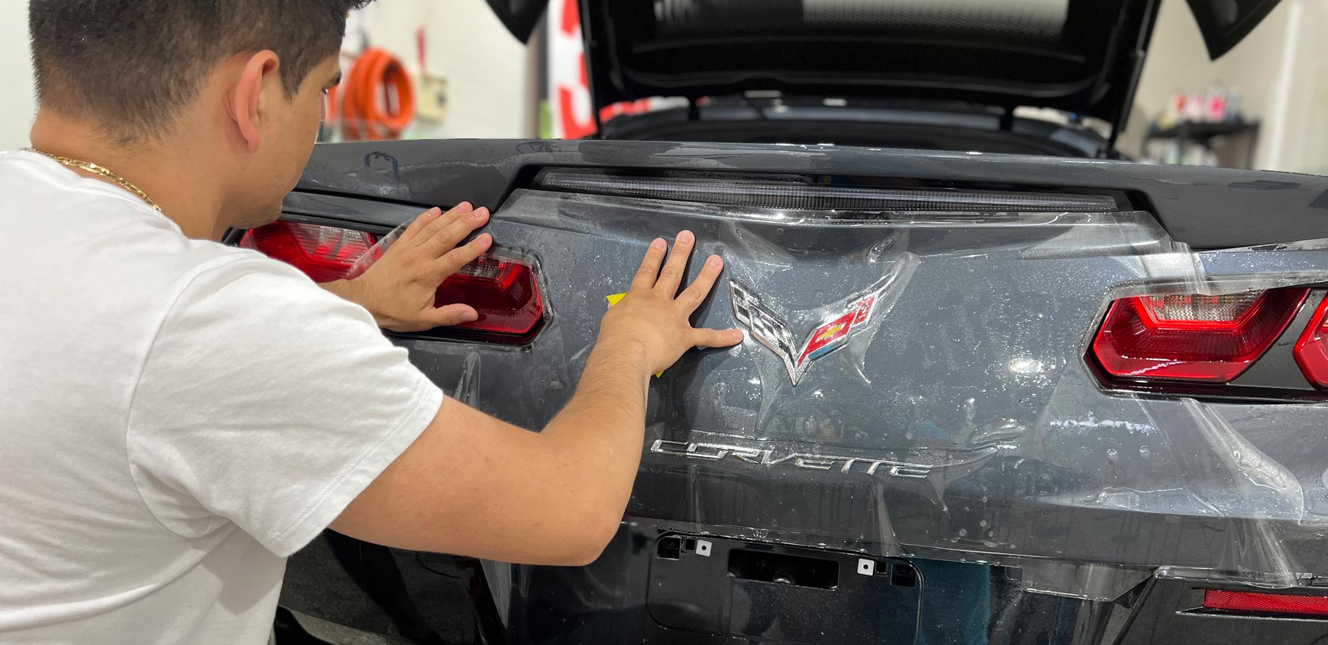 Vehicle detailing showing application of clear bra film