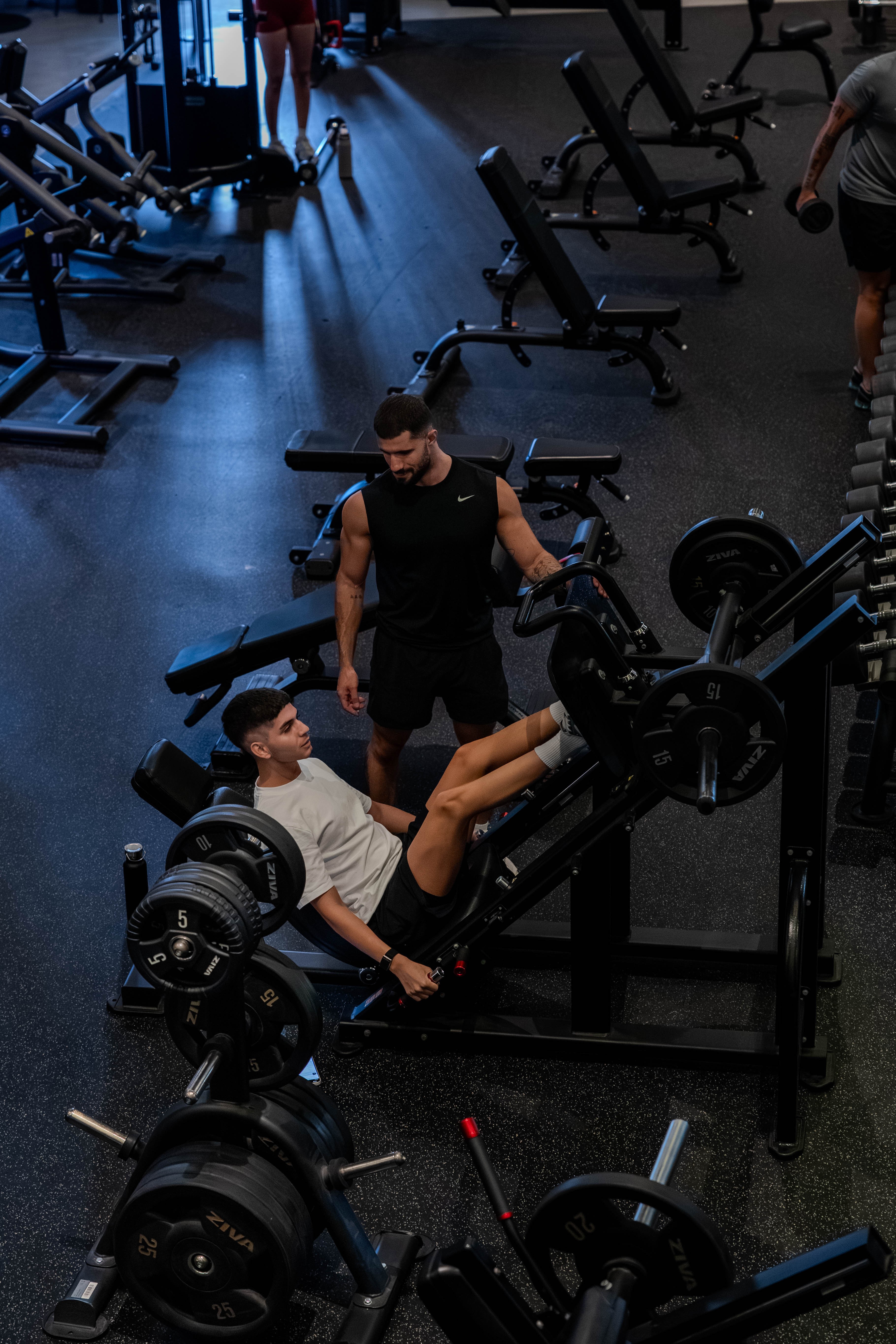 Rachel, personal trainer, looking to the side confidently in a fitness studio