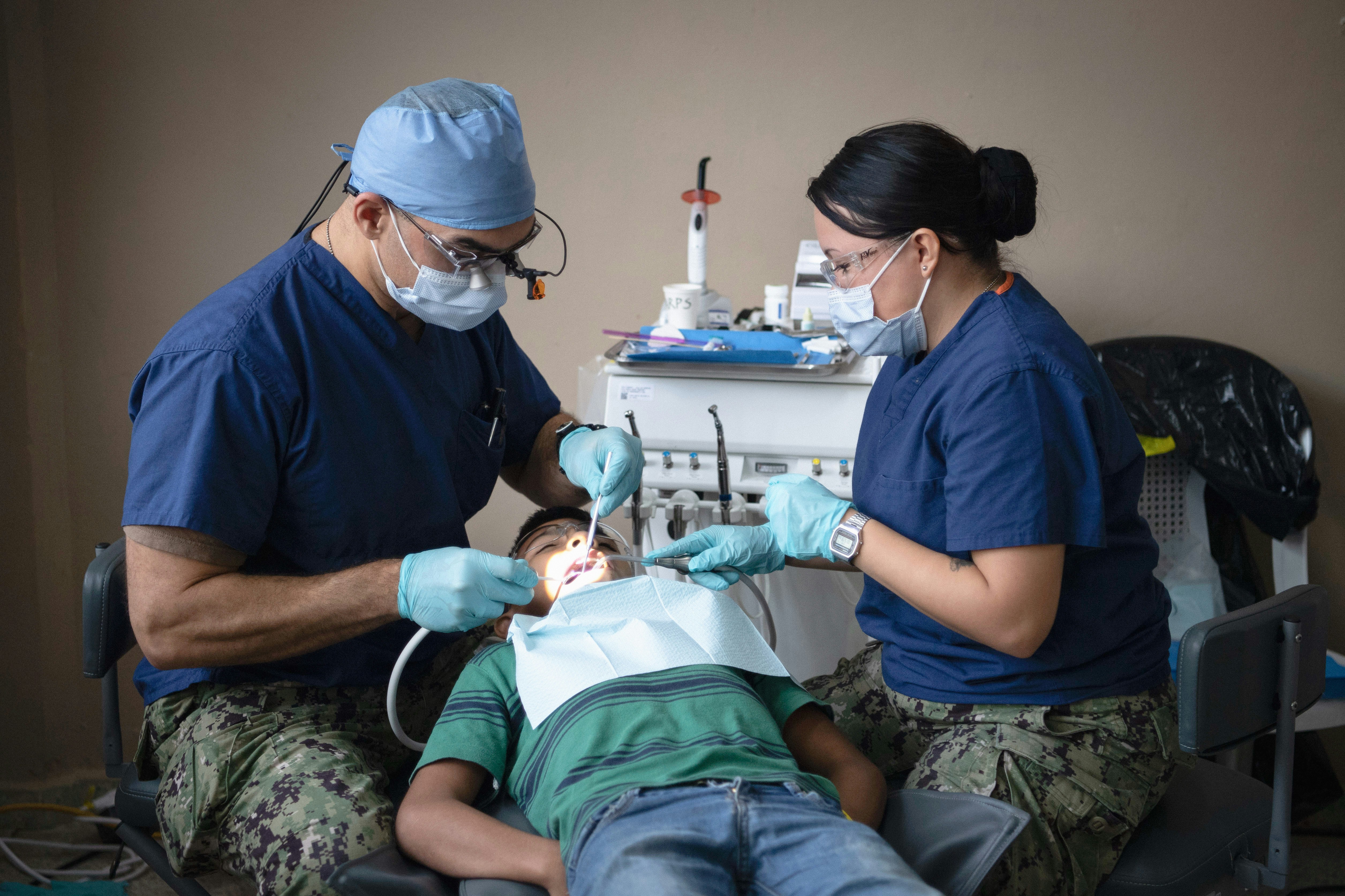 221105-N-TR141-1055 PUERTO CORTES, Honduras (Nov. 5, 2022) Lt. Cmdr. Jonathan Blaze Negron, a dentist from Port St. Lucie, Florida, and Hospital Corpsman Britny Cruz-Rivera, a dental technician from Clearwater Florida, both attached to the hospital ship USNS Comfort (T-AH 20) for Continuing Promise 2022, conduct dental procedures for Hondurans at a medical site in Puerto Cortes, Honduras, Nov. 5, 2022. Comfort is deployed to U.S. 4th Fleet in support of CP22, a humanitarian assistance and goodwill mission conducting direct medical care, expeditionary veterinary care, and subject matter expert exchanges with five partner nations in the Caribbean, Central and South America. (U.S. Navy photo by Mass Communication Specialist 1st Class Benjamin Lewis)