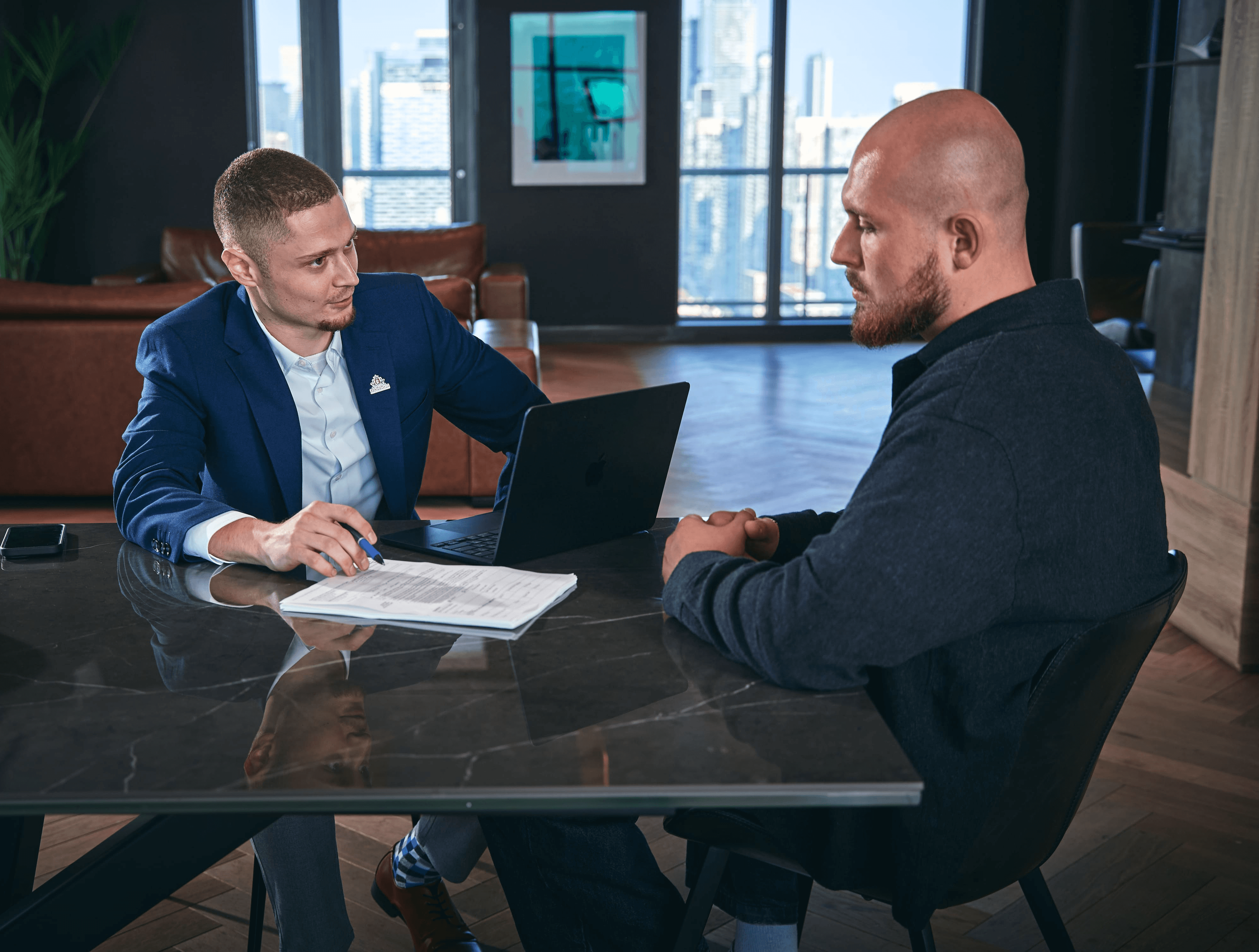 Modern blue metal cubical building facade against a clear sky