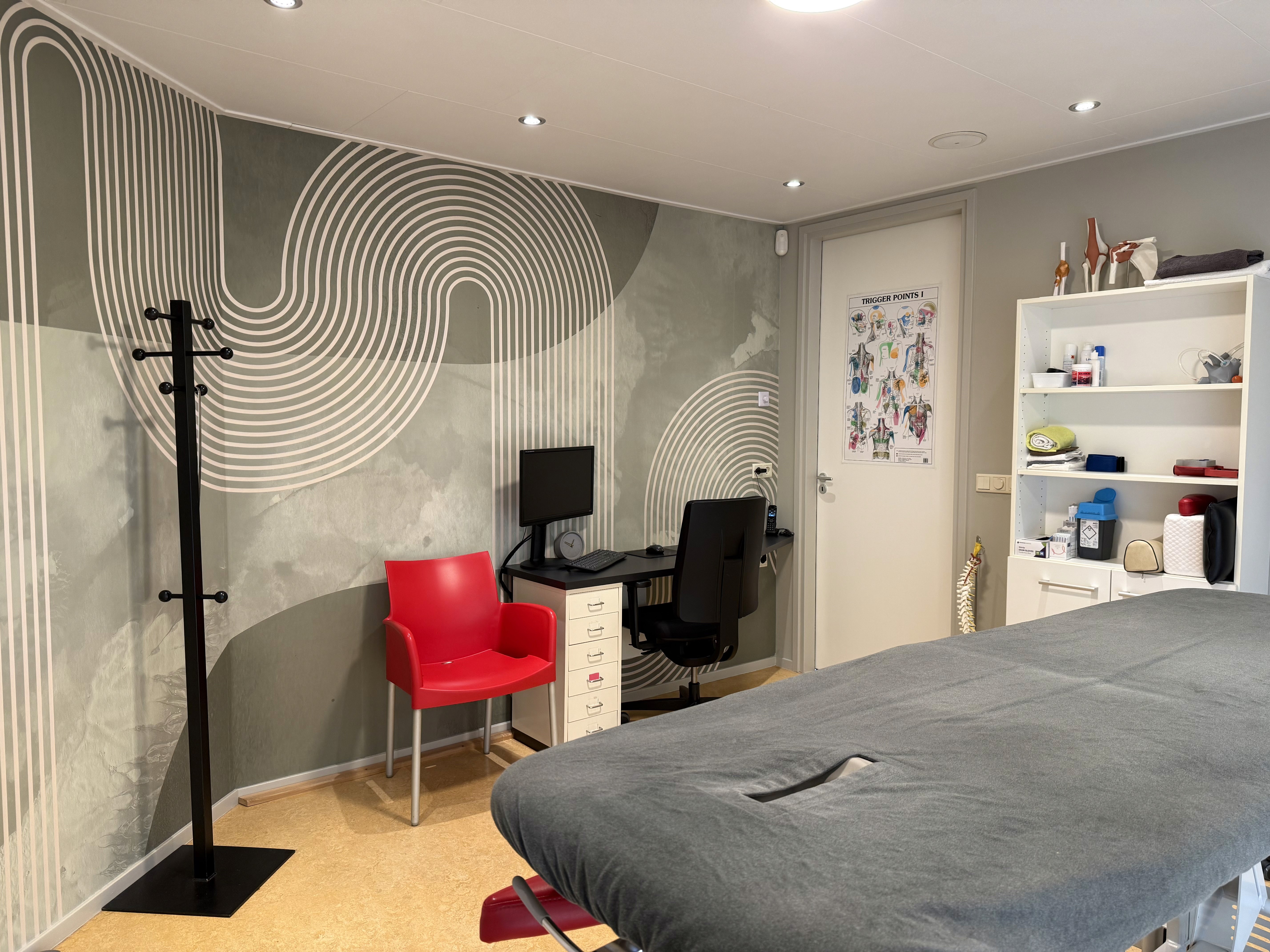 black bed frame on brown wooden parquet floor