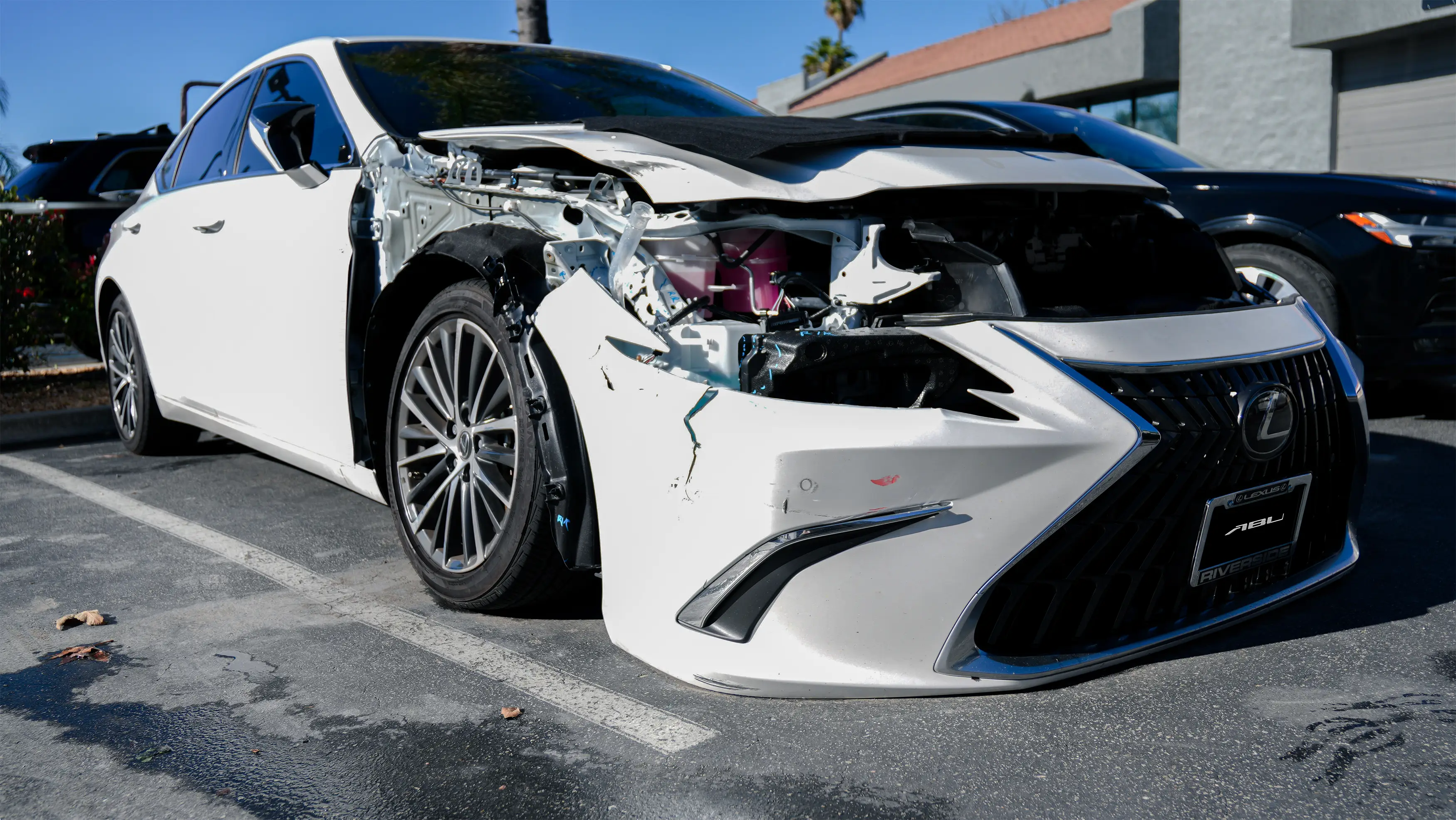 Lexus sedan with front-end collision damage prior to repair at Auto Body Unlimited.