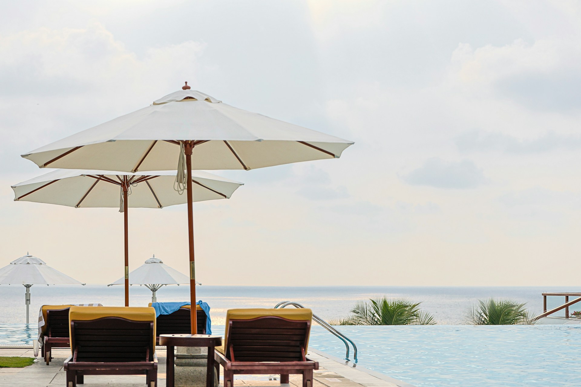 Swimming pool area with sun umbrellas and lounge chairs