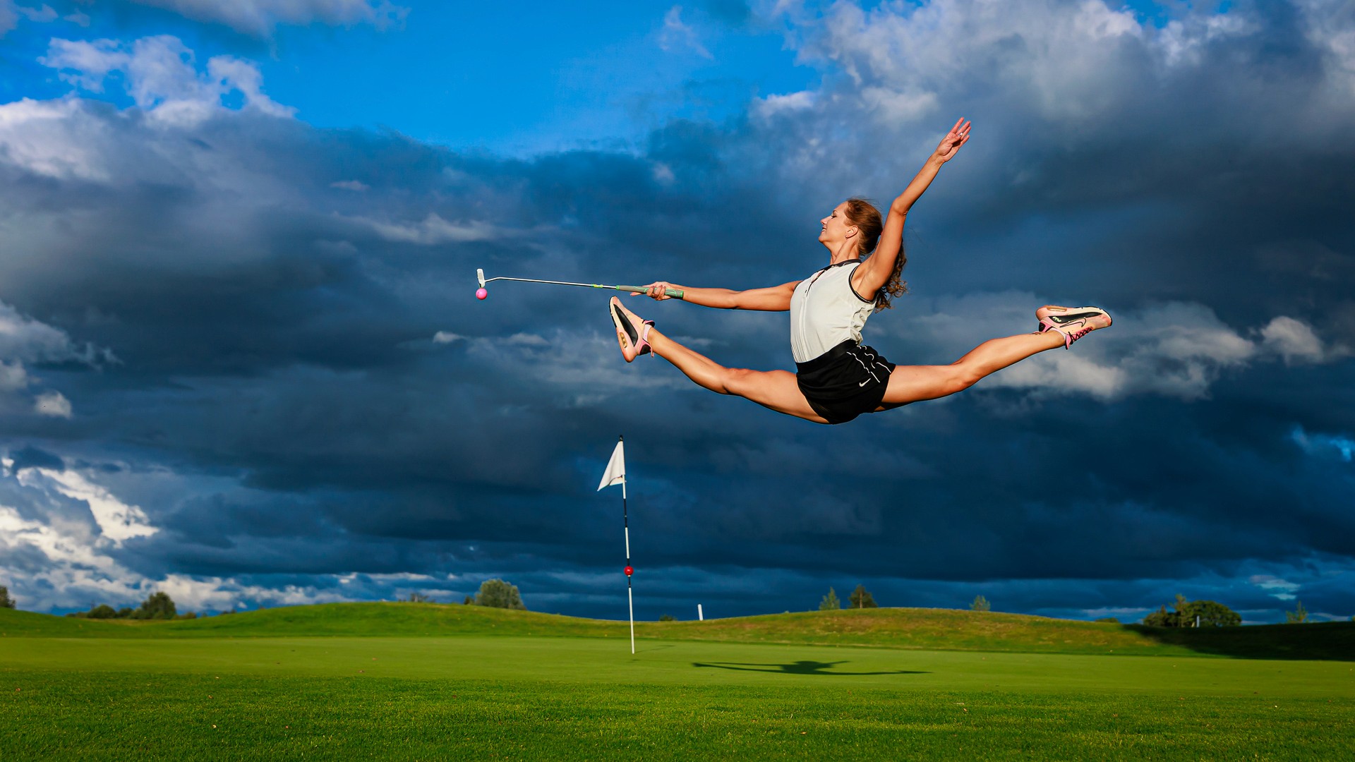 Golf course - Joy Unleashed - putter, ball, flag - against stormy sky. Cover image for What Golf Taught Me About Leading Teams. Photo by Mats Soomre. #MomentsBySoomre