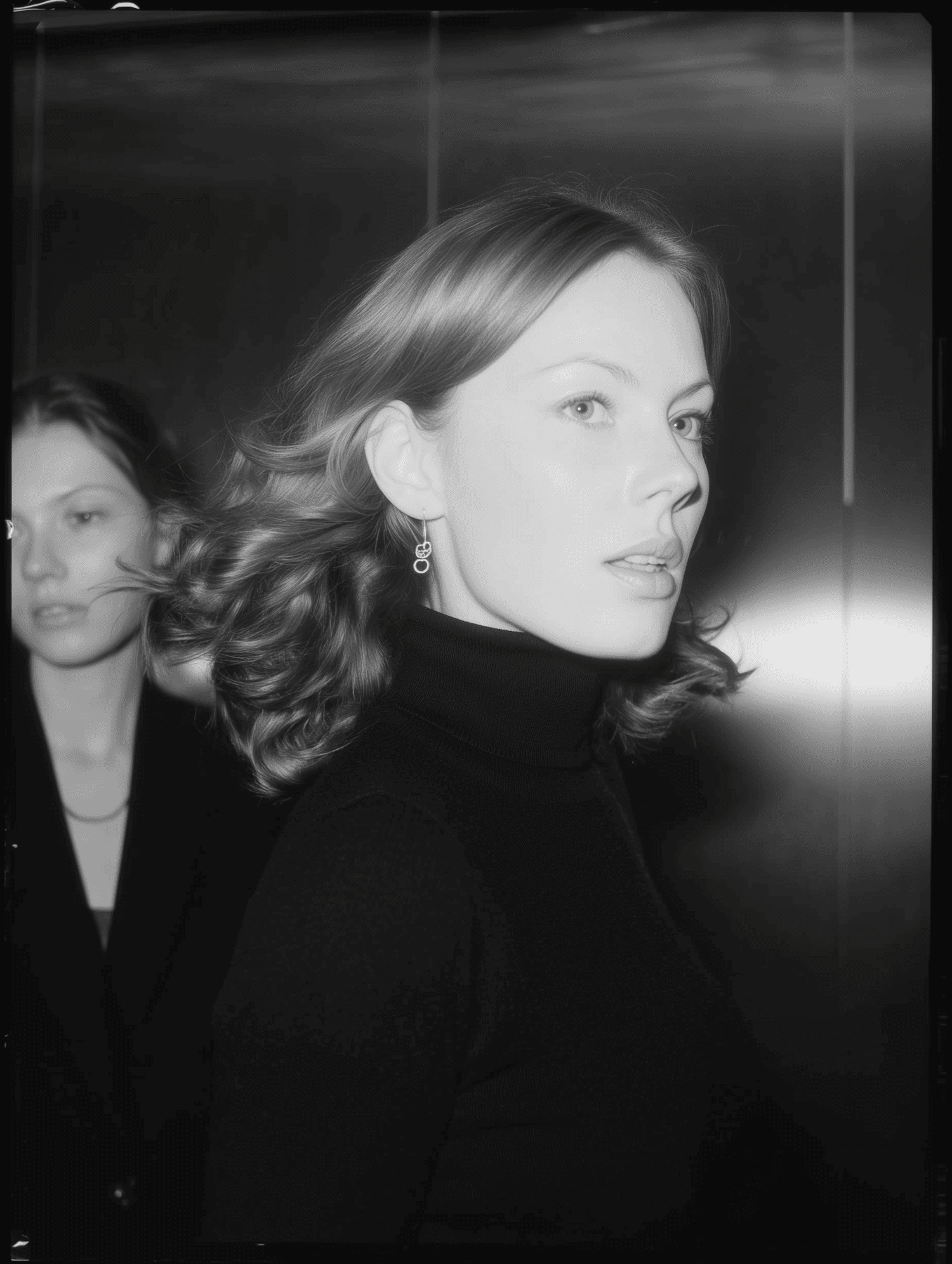 Woman in black turtleneck looking sideways in soft light