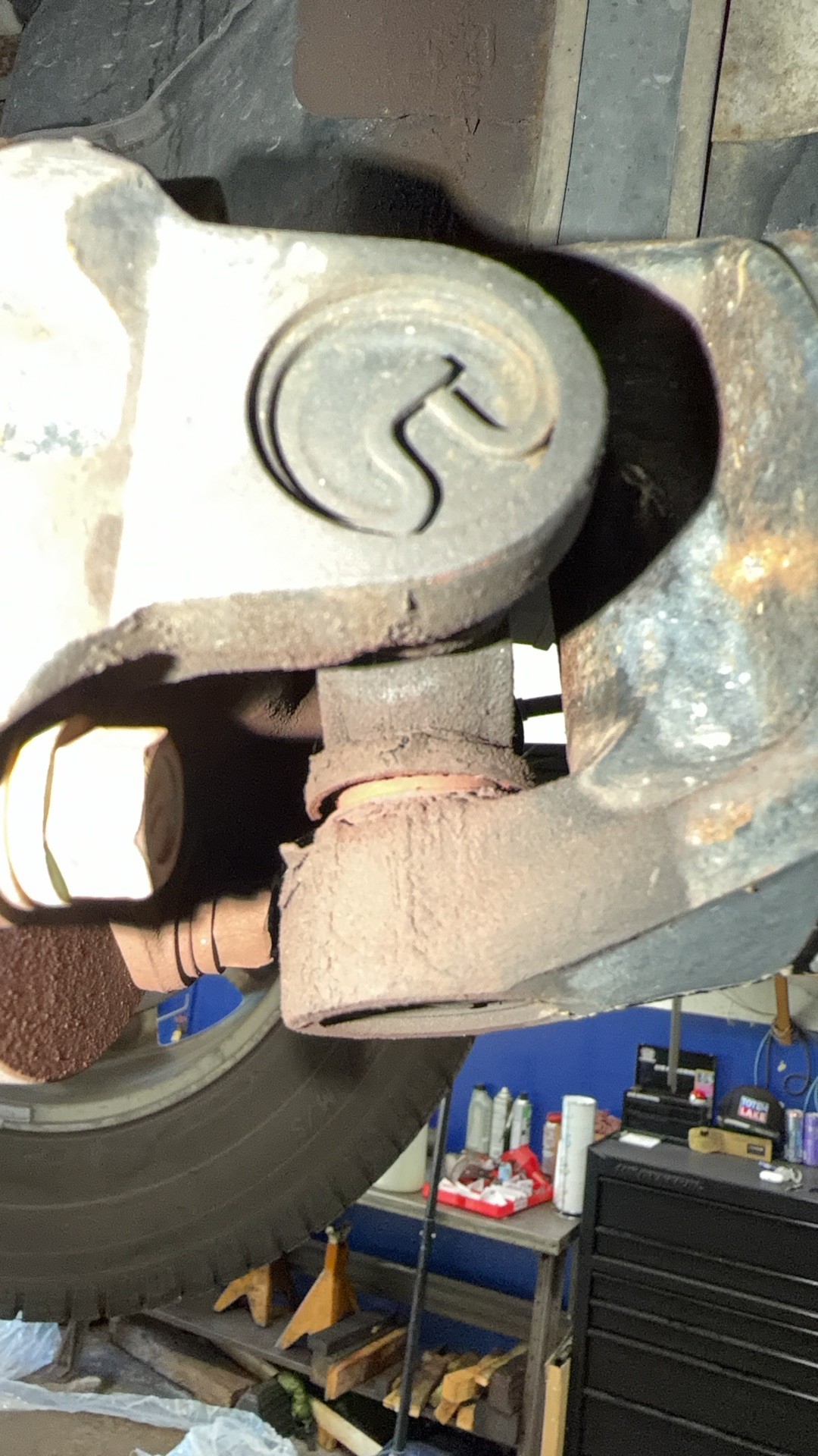 Failed rear driveshaft U-joint on the 2006 Toyota Tacoma, coated in rust-colored powder