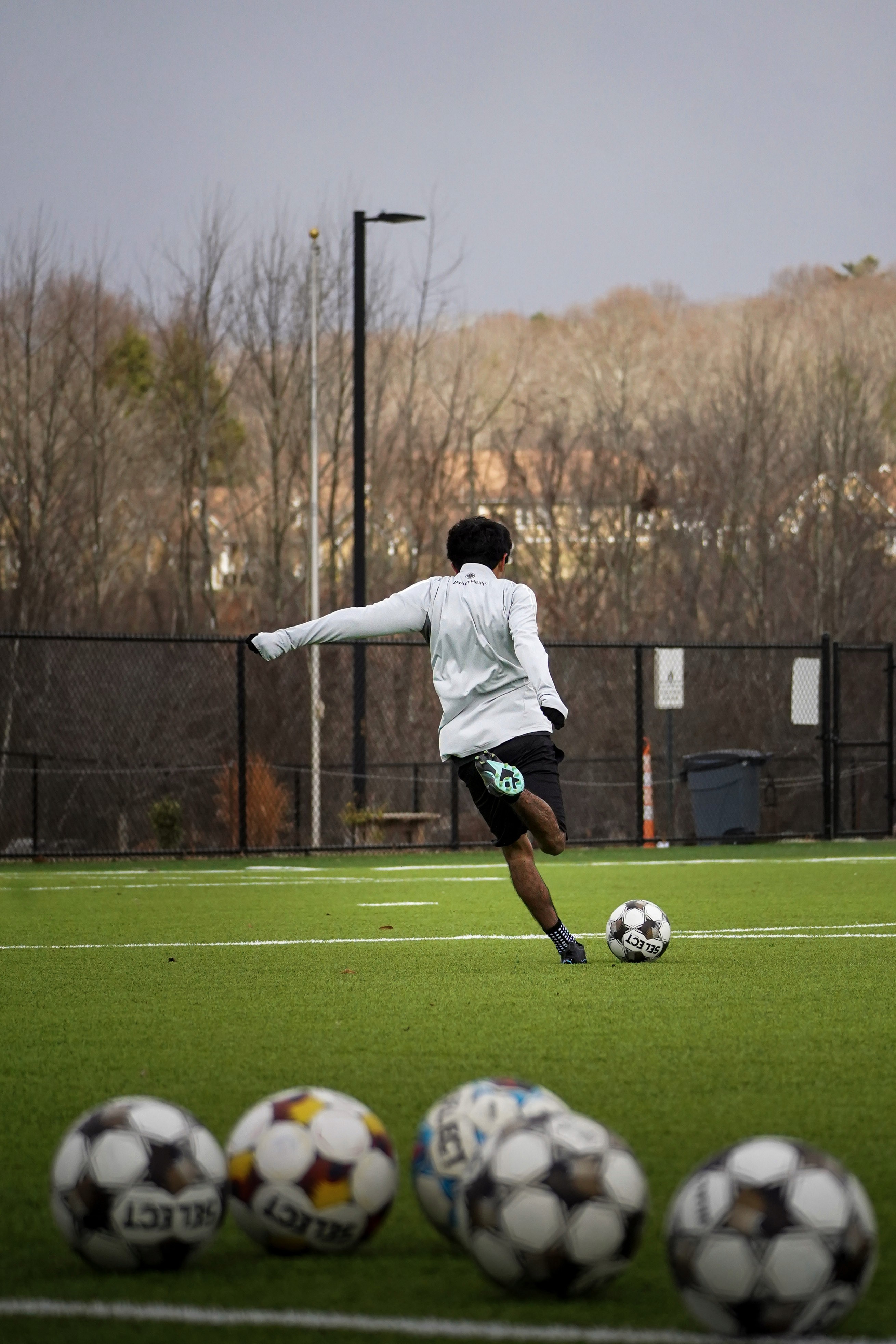 a person kicking a soccer ball on a field