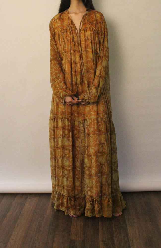 SAIA vintage silk maxi dress in black with beige floral motifs, flowy silhouette, versatile deep V or tied neckline, and elastic cuff long sleeves.