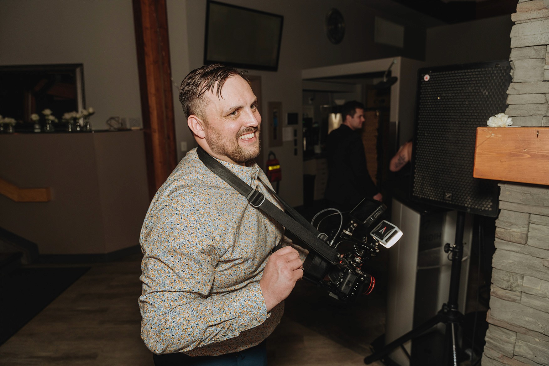Man With Weddign videography Equipment in his hands at a wedding