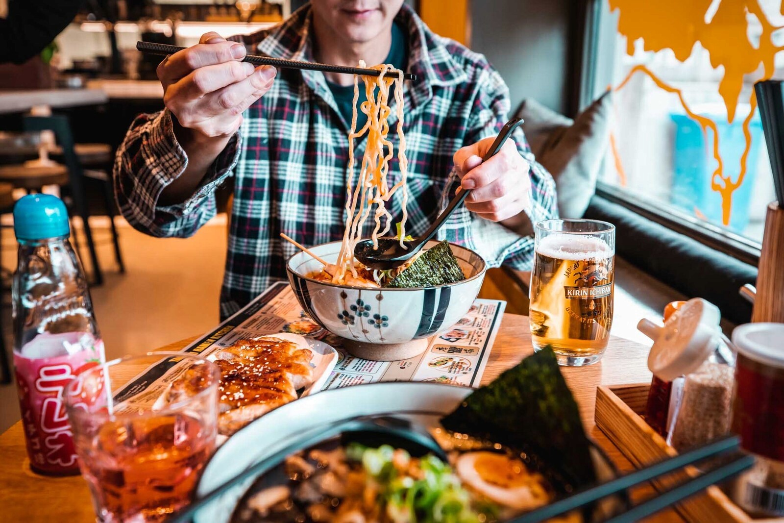 Image of someone eating ramen at takumi