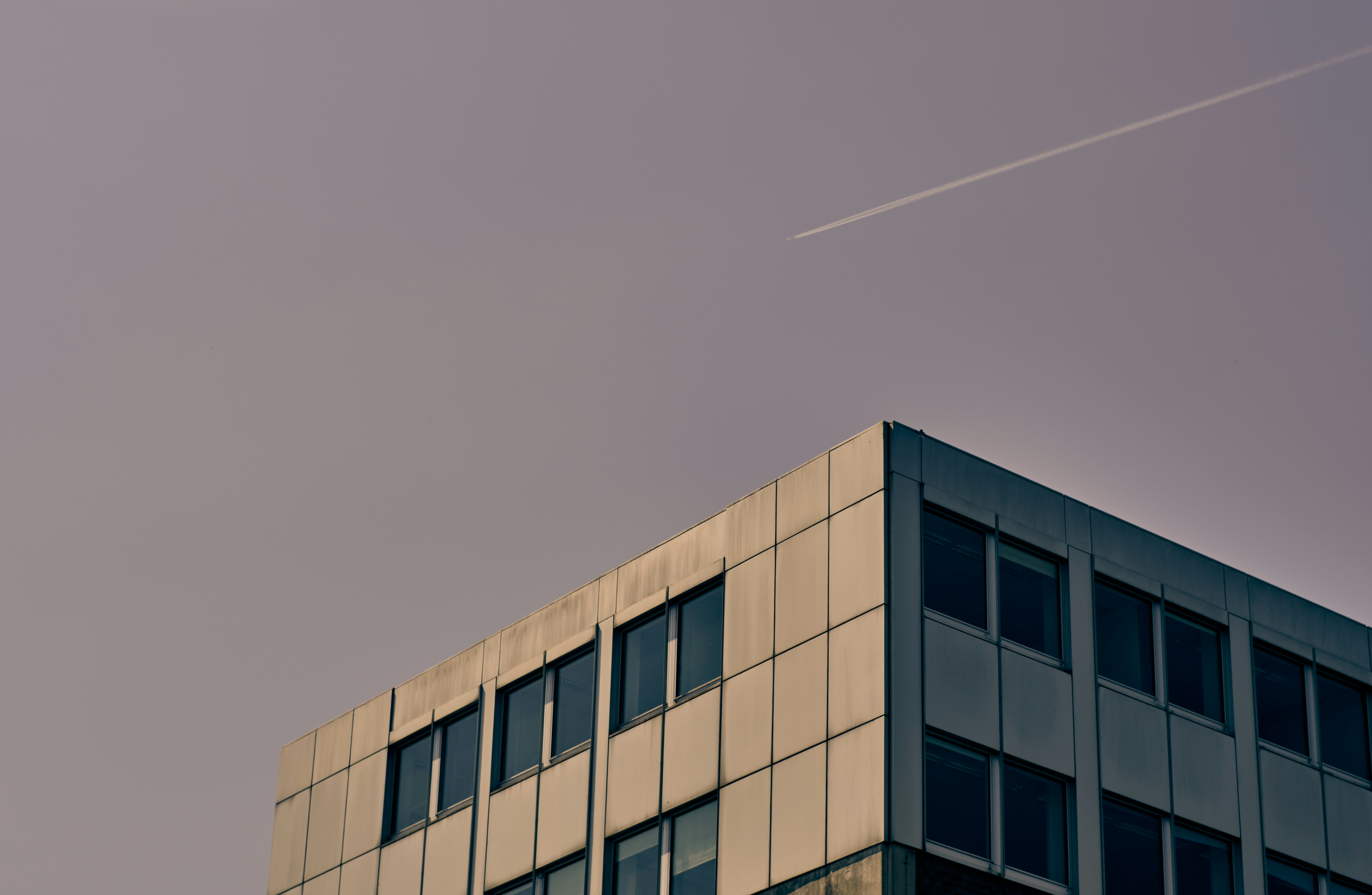 brown concrete building under gray sky