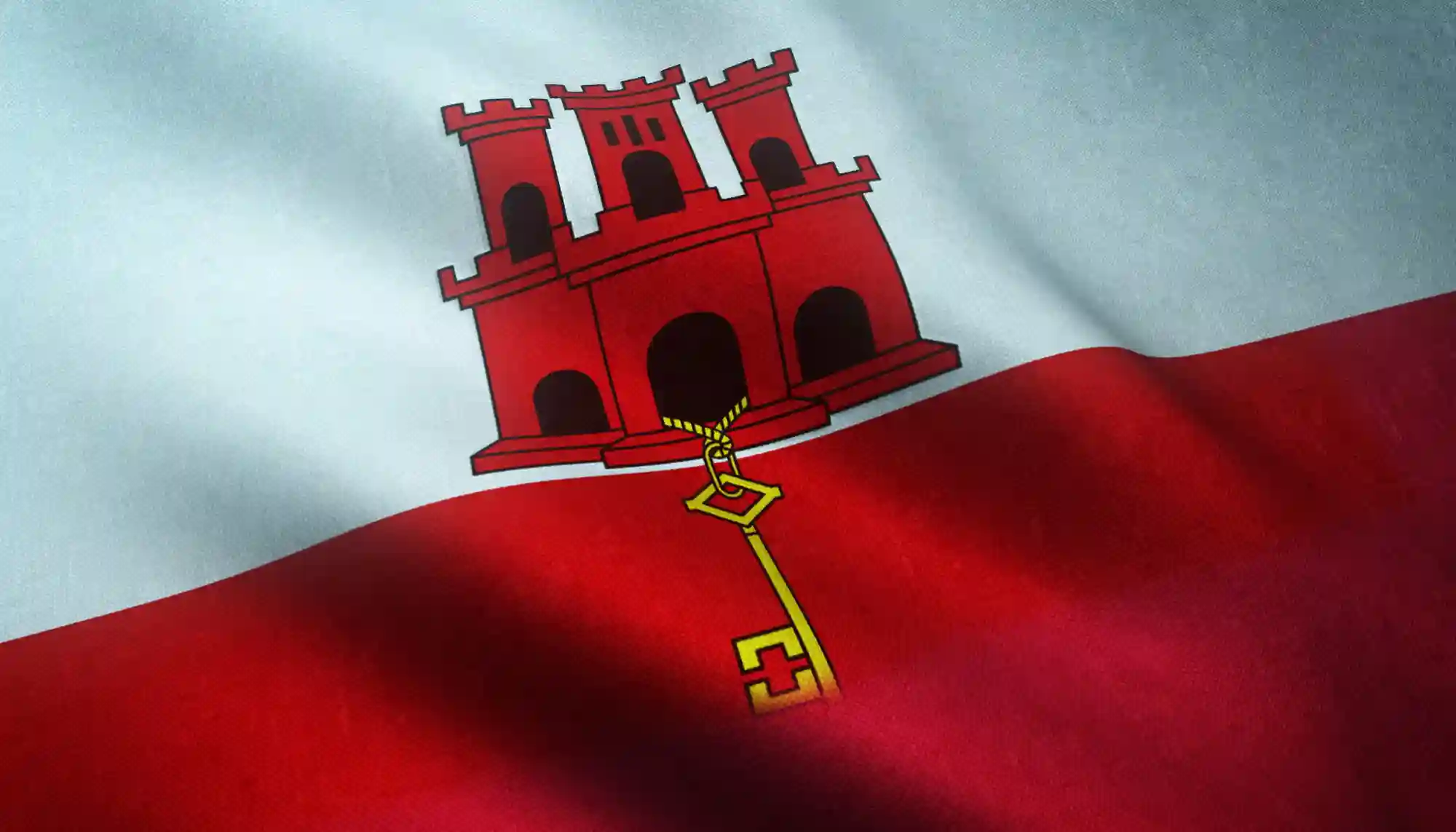The flag of Gibraltar waving, representing the territory’s specific legal framework and its role in international digital commerce.