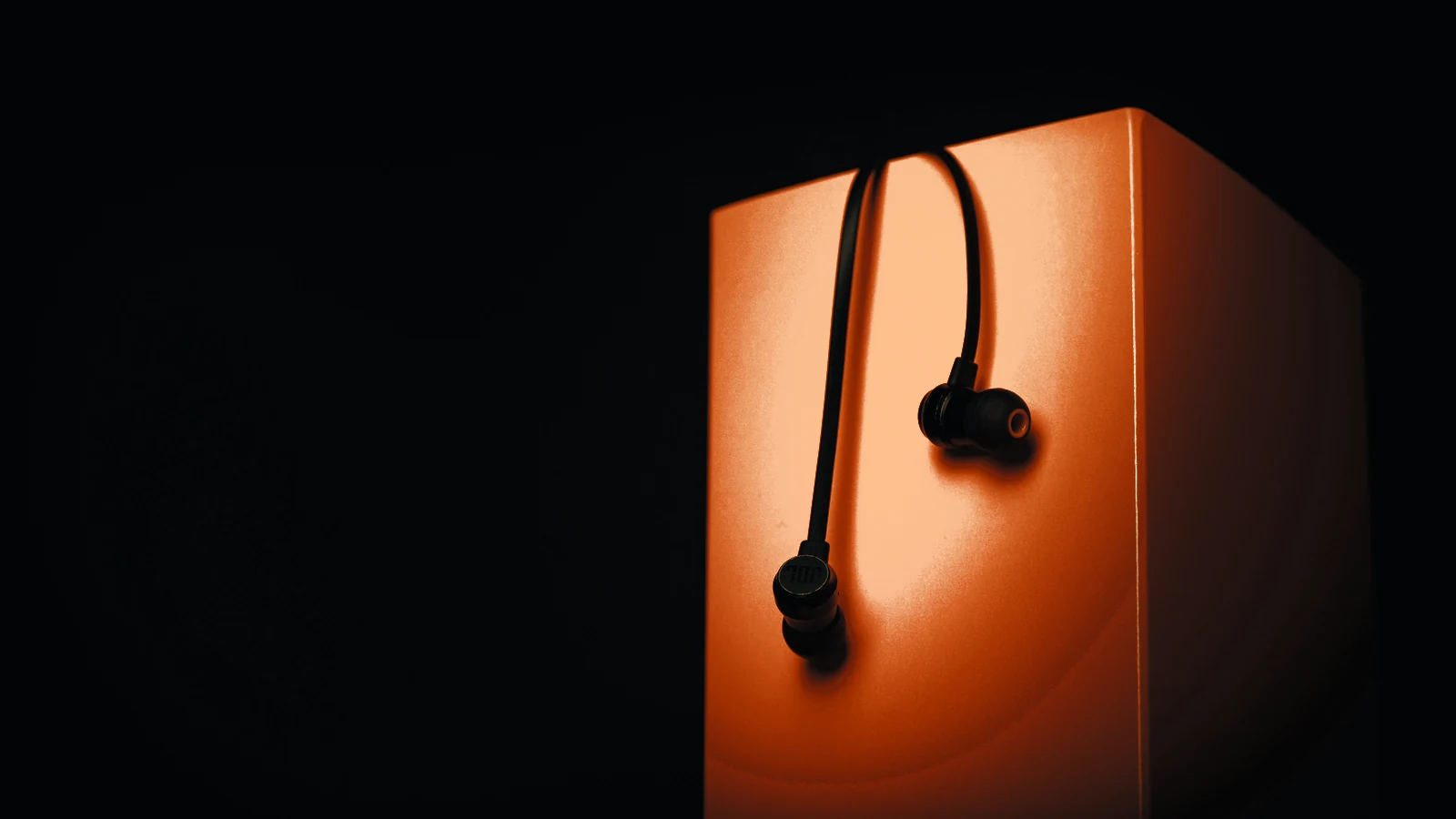 Earbuds on an orange box