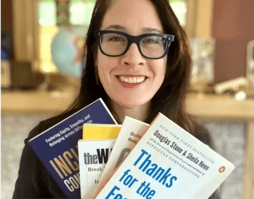 amanda scotese smiling with books about communication and leadership