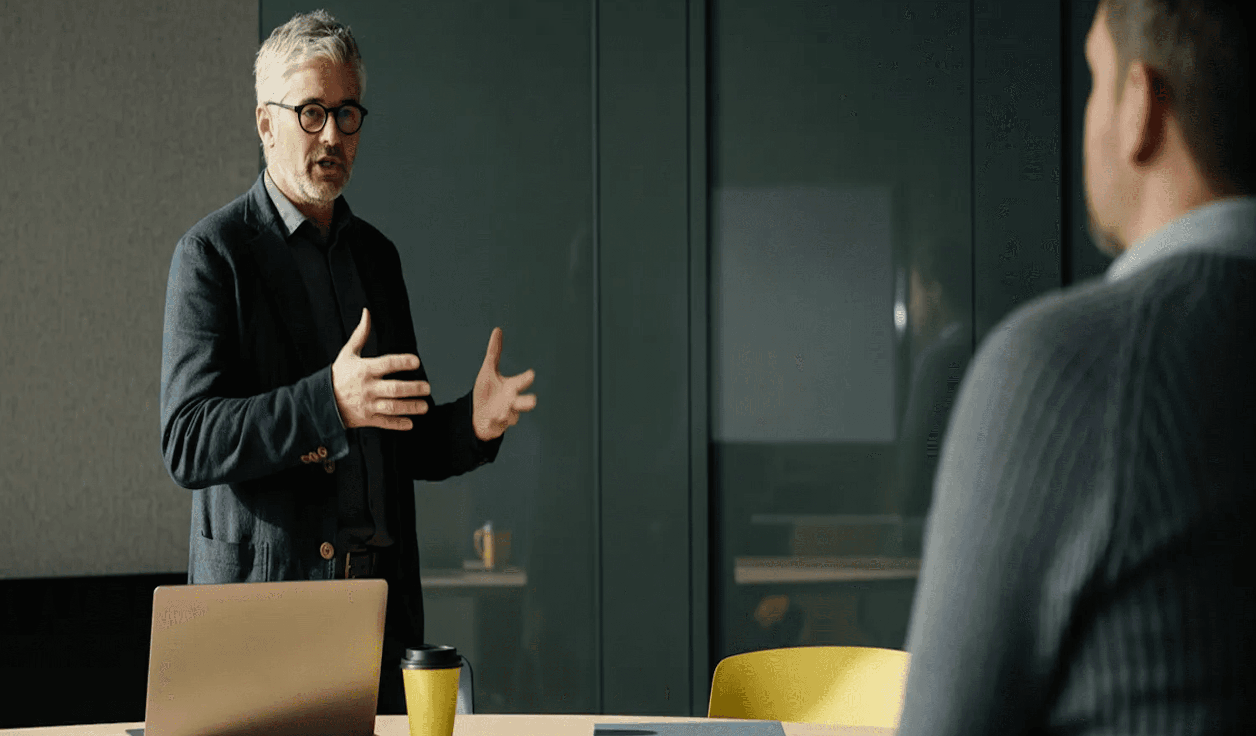 Senior professional leading office meeting.